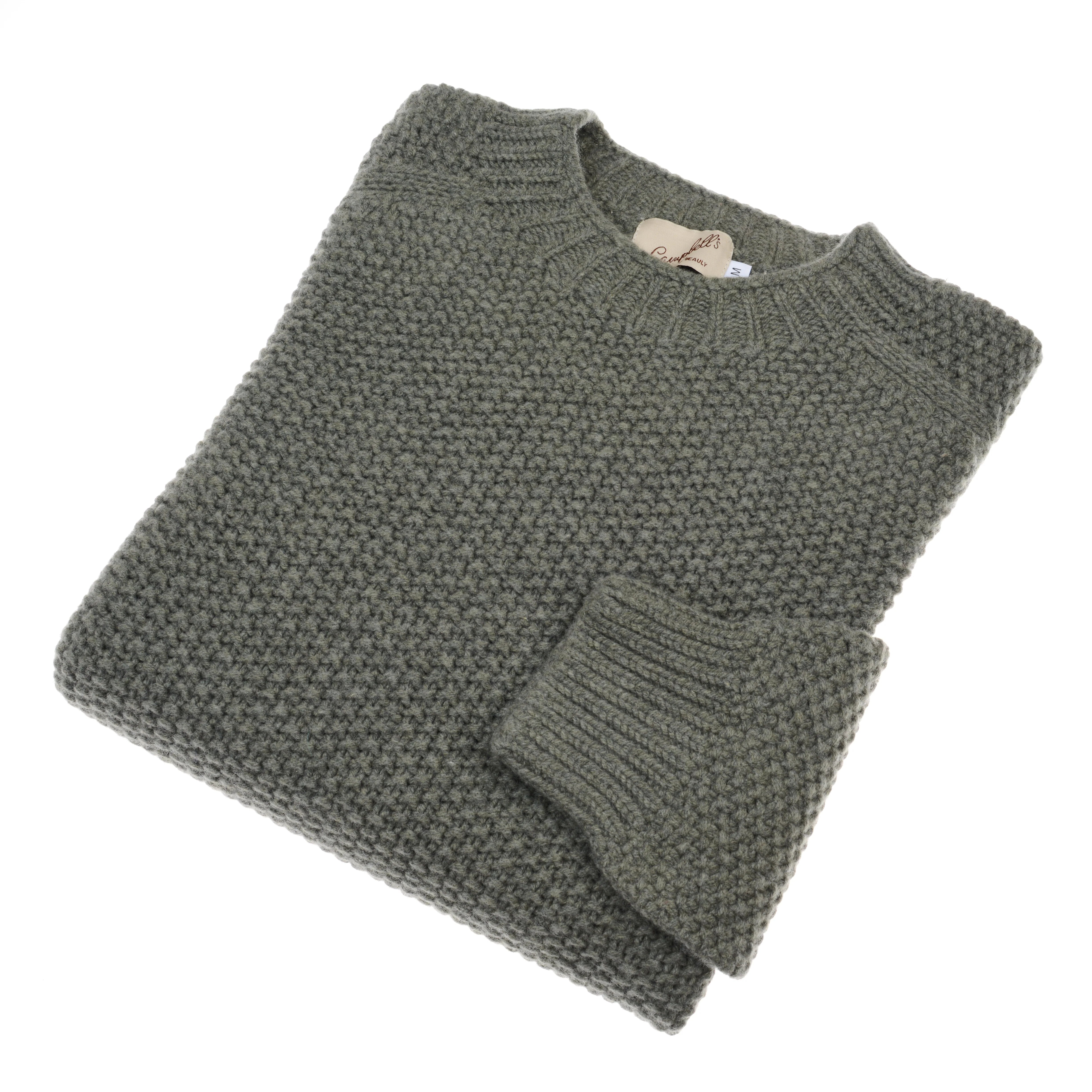 A neatly folded, chunky-knit gray Auld Stock Moss Stitch Jumper by Campbell's of Beauly, featuring a visible tag at the neckline, knitted in Scotland and displayed on a white background.