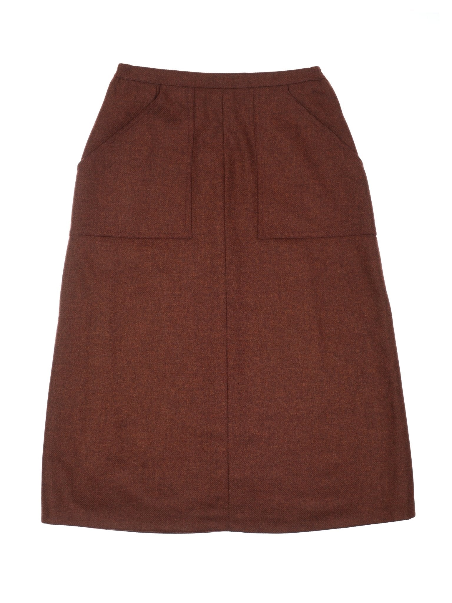 The Auld Stock A-Line Skirt by Campbell's of Beauly is a brown, knee-length women's tweed skirt with two front patch pockets and a straight silhouette, shown laid flat on a white background.