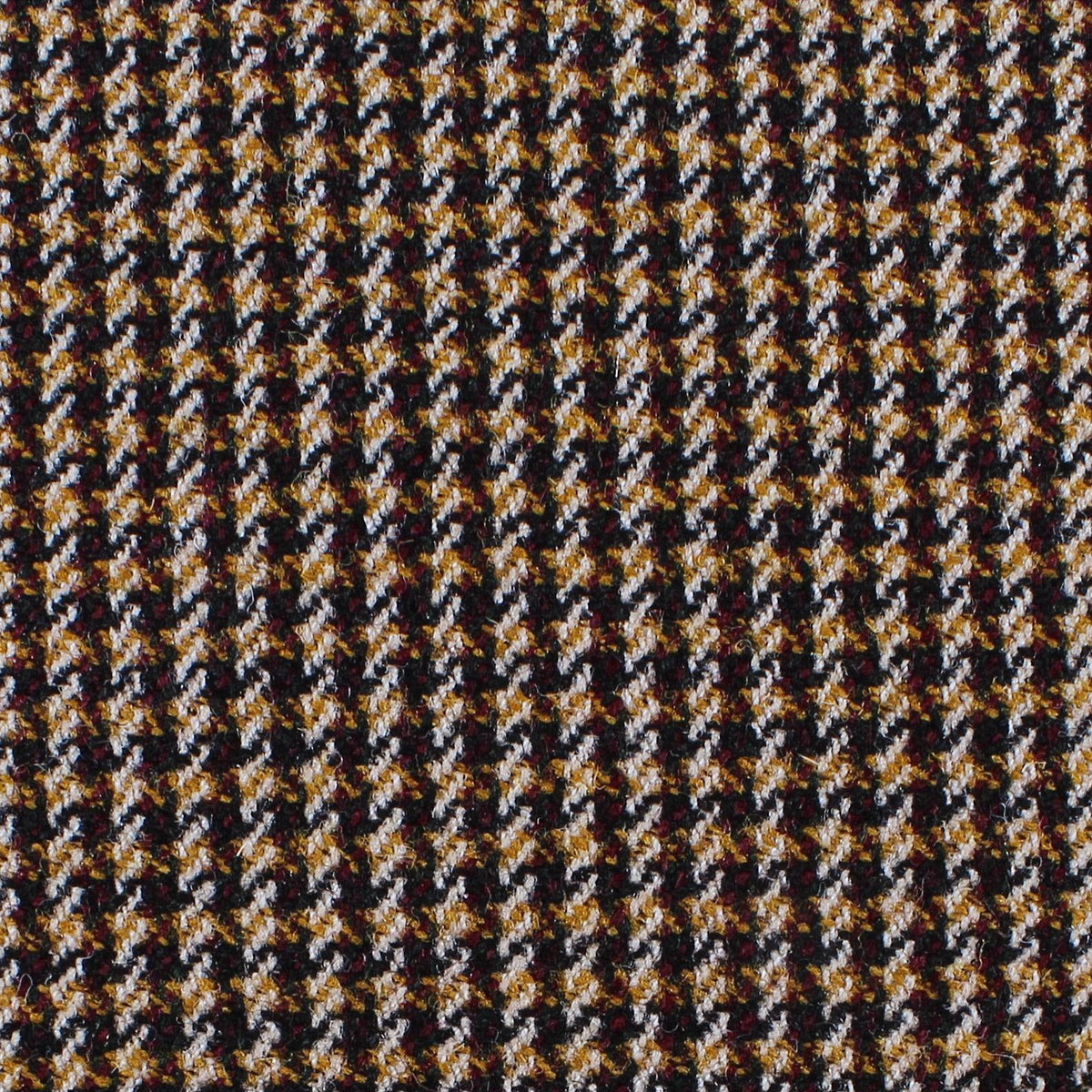 Estate Tweed 005 heavyweight sporting cloth in a black, white, and golden-brown houndstooth pattern.