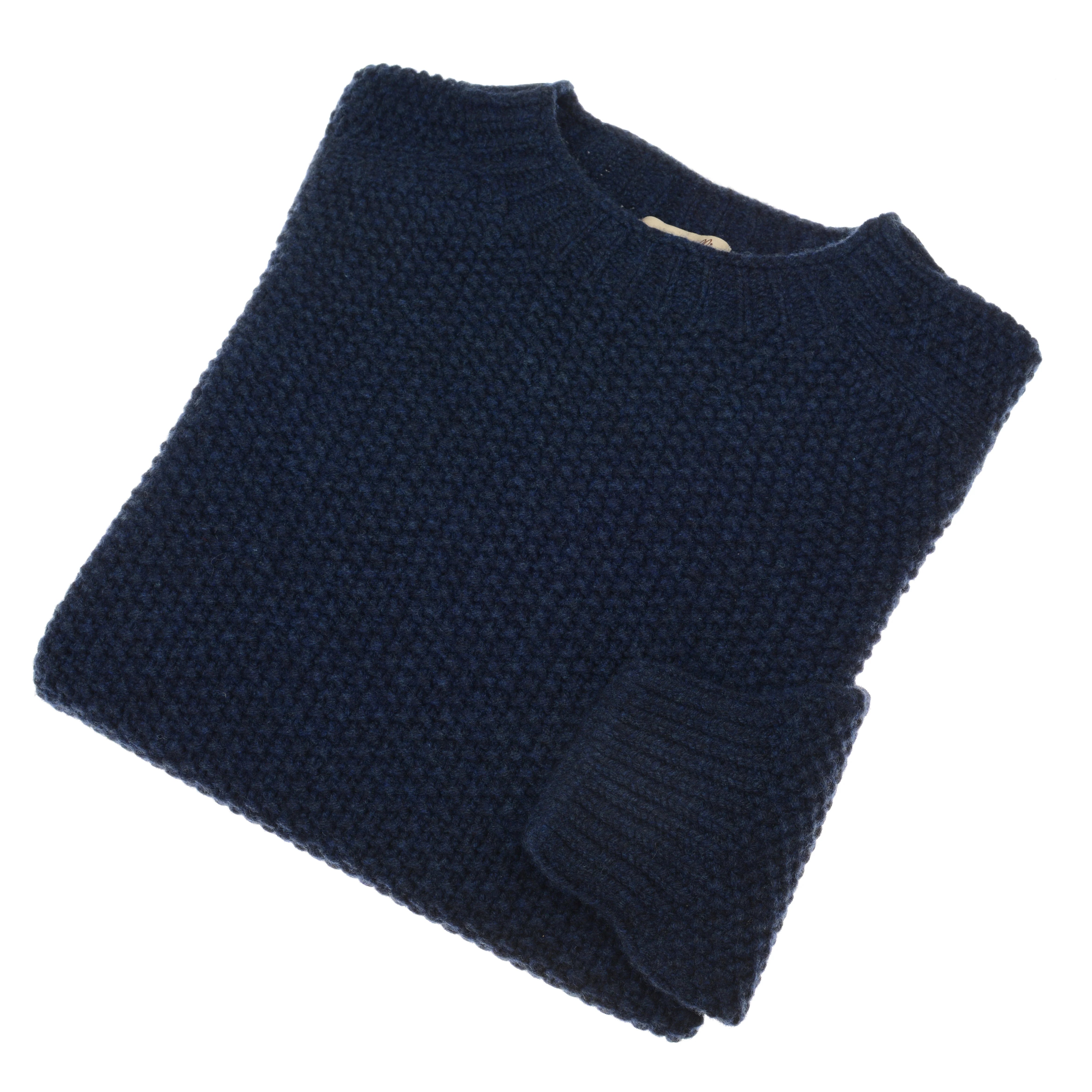 A neatly folded dark blue Auld Stock Moss Stitch Jumper by Campbell's of Beauly, crafted in Scotland with a textured moss stitch and classic crew neckline, displayed against a white background.