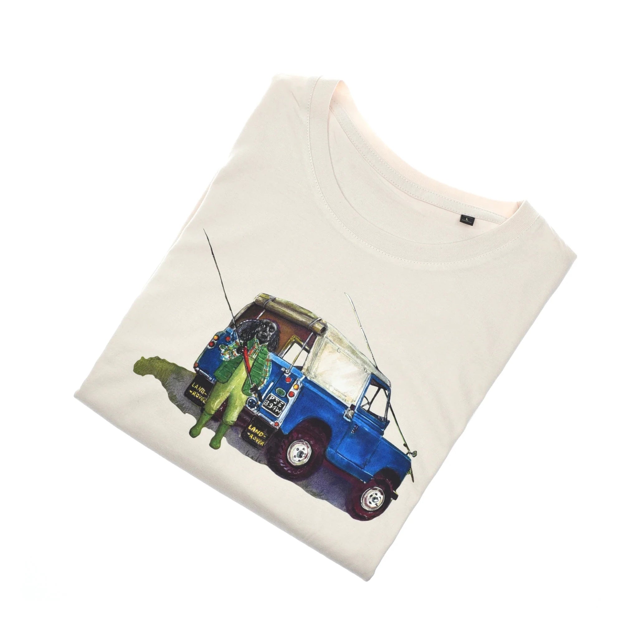 The Auld Stock Land Rover Cocker T-Shirt by Campbell's of Beauly is a folded white tee featuring a blue and white off-road vehicle with a fisherman holding fishing rods—ideal for country clothing fans.