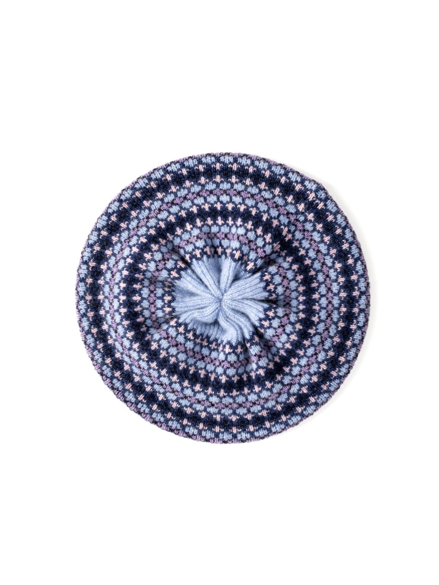 The Campbell’s of Beauly Fairisle Beret in Bluebell showcases a classic Fairisle pattern in blue and purple hues, accented by a light blue pom-pom at the center, and is photographed from above against a white background. Crafted from soft lambswool and inspired by traditional Scottish knitting techniques, this beret blends timeless style with cozy comfort.