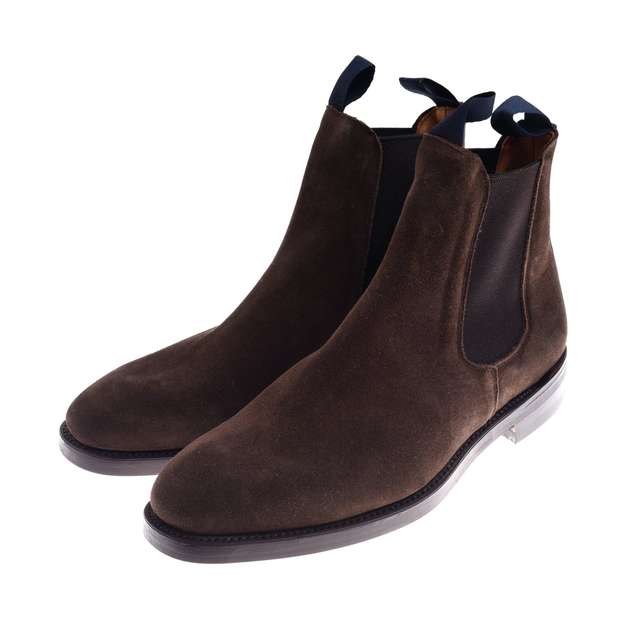 The Auld Stock Suede Chelsea Boots by Campbell's of Beauly are dark brown suede boots with navy pull tabs and a sturdy Commando sole, made by a British manufacturer and shown on a white background.