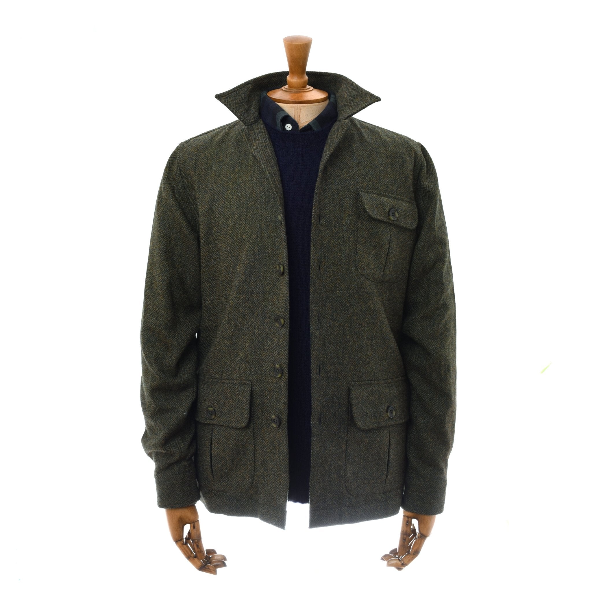 A mannequin displays the Campbell's of Beauly Casual Tweed Shacket in dark olive green, featuring three front pockets, layered over a black sweater and beige collared shirt, against a white background.
