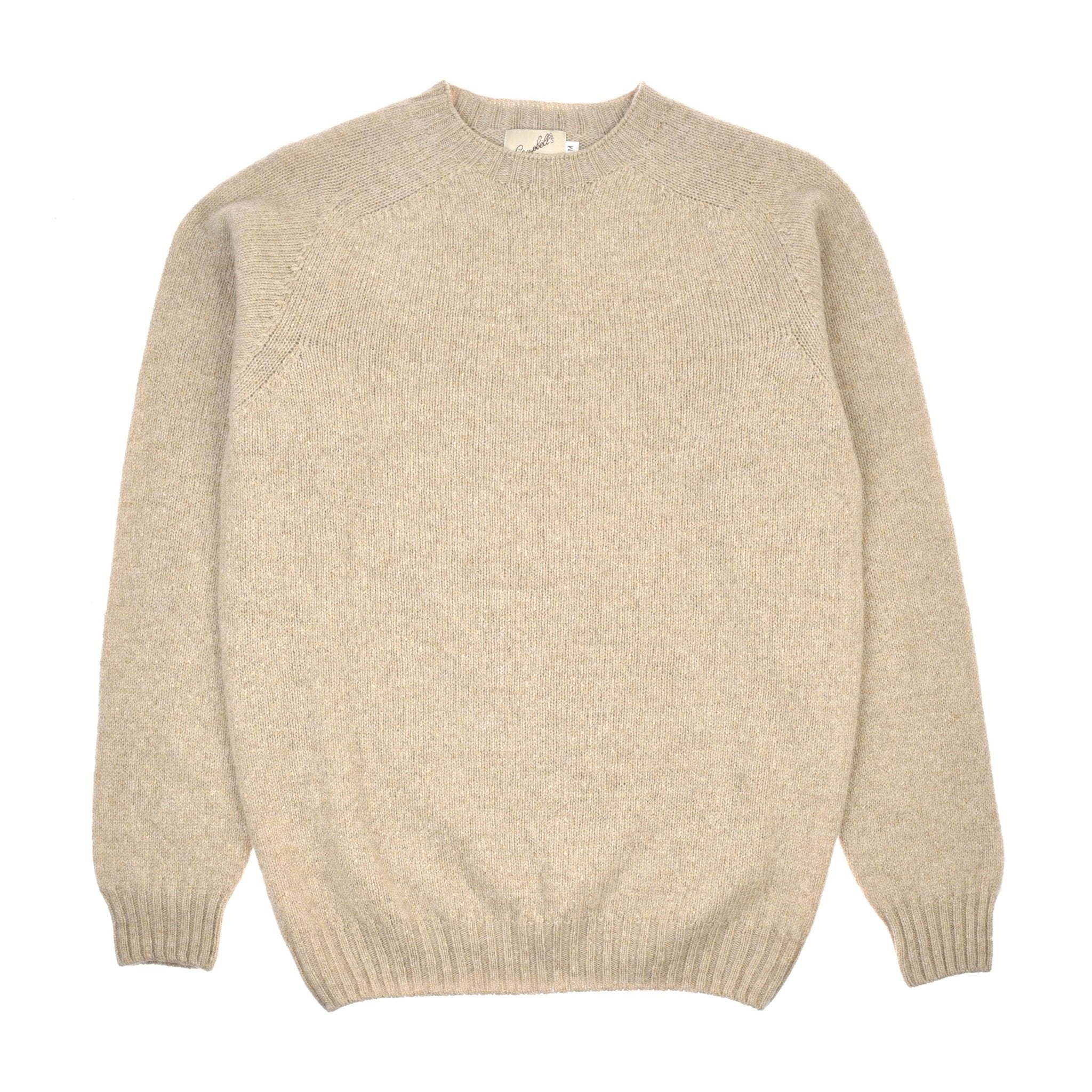 The Campbell's of Beauly Shetland Jumper in beige is a classic long-sleeve knit laid flat on white, featuring ribbed cuffs, collar, and hem for timeless style and comfort.