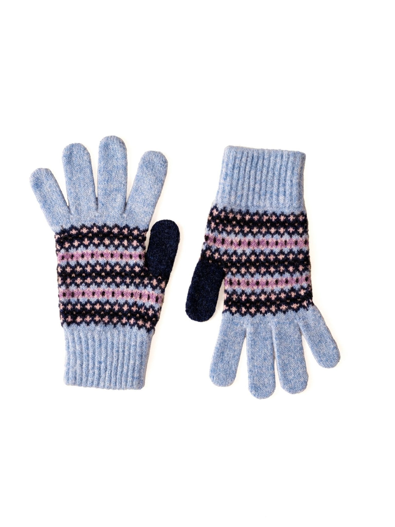 A pair of Campbell’s of Beauly Fairisle Gloves in Bluebell, featuring ribbed cuffs and a Fairisle pattern in pink, white, and black stripes across the middle. The thumb and index finger are dark blue. Inspired by the traditional knitwear of the Scottish Borders, the gloves are laid flat on a white background.