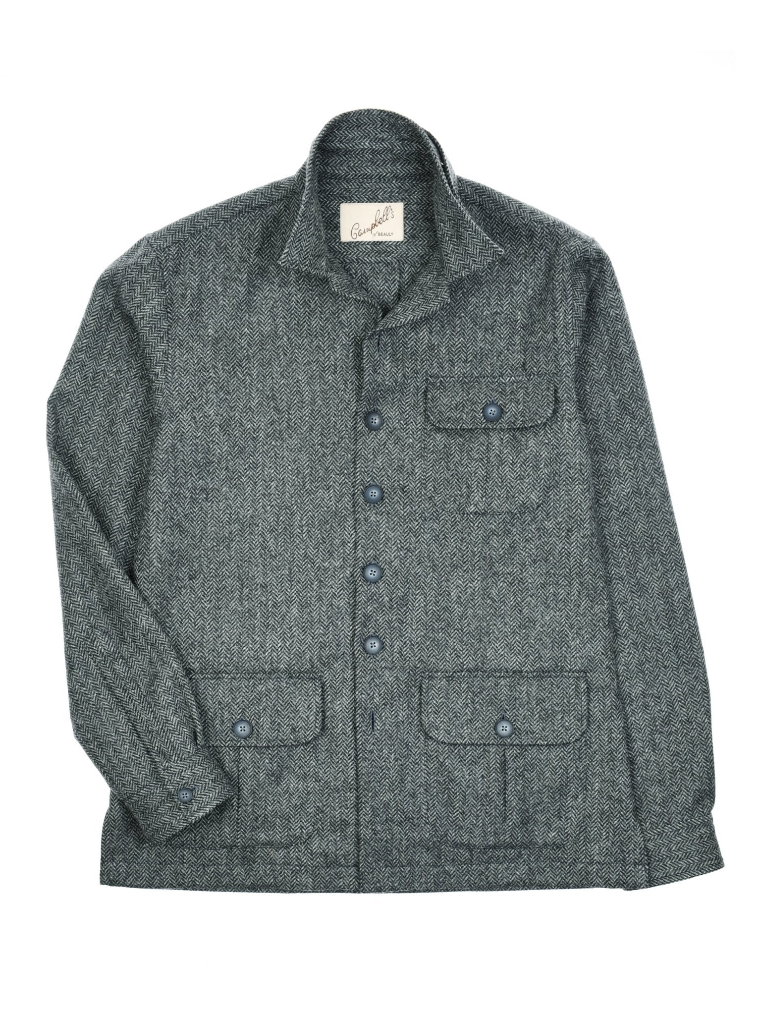 The Campbell's of Beauly Casual Tweed Shacket is a gray wool piece with relaxed tailoring, a collar, long sleeves, four front pockets (three button-flap, one open chest), textured fabric, and an inner label for a modern British tweed look.