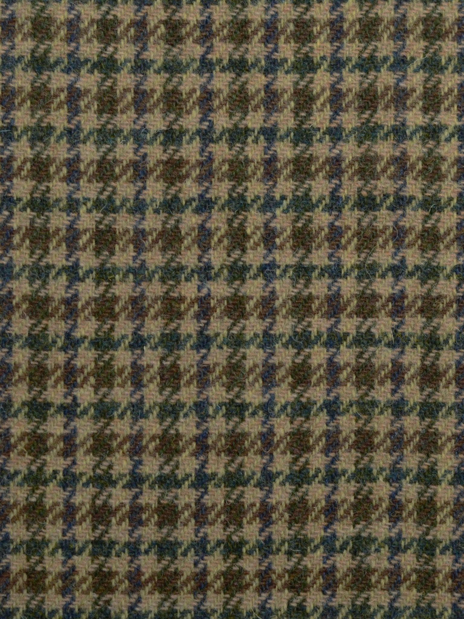 A close-up of Harris Tweed 93912 by Campbell's of Beauly, featuring a houndstooth pattern in brown, green, and beige hues that highlights classic Scottish weaving in a timeless geometric design.