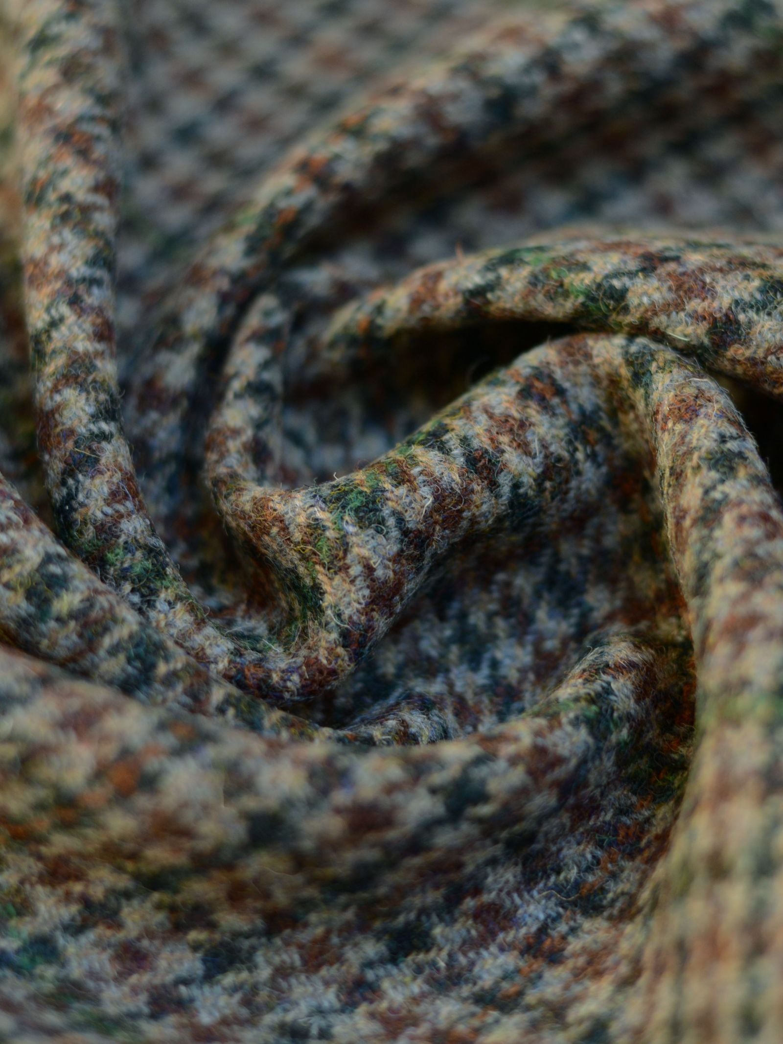 A close-up of House Tweed 93900 by Campbell's of Beauly highlights the intricate patterns and artistry found in this featherweight Scottish tweed.