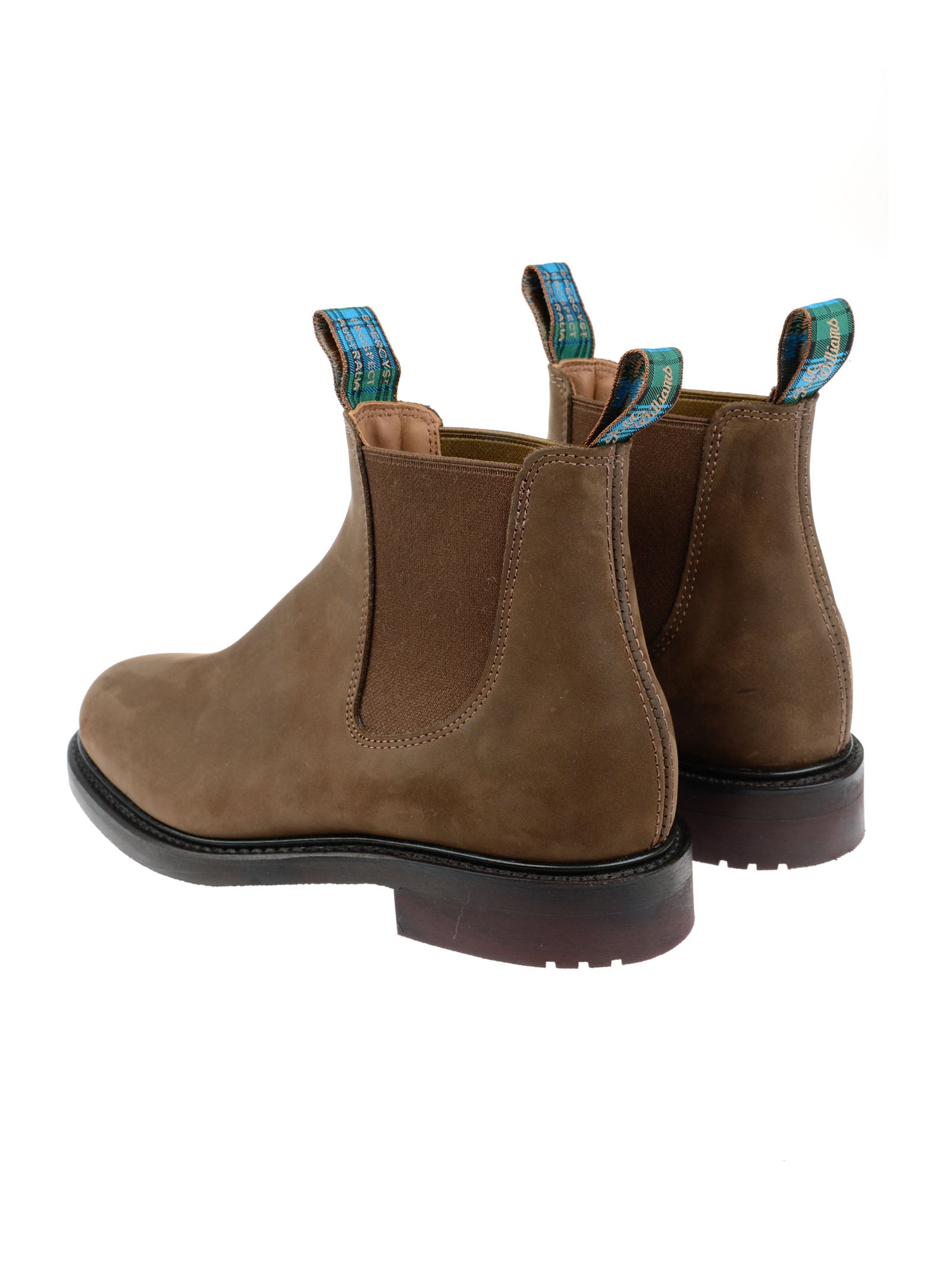 The Men's R.M.Williams Highlander Boot by R.M.Williams x Campbell's of Beauly features brown premium leather, elastic side panels, dark soles, and blue pull tabs, displayed from a rear side angle on a white background.
