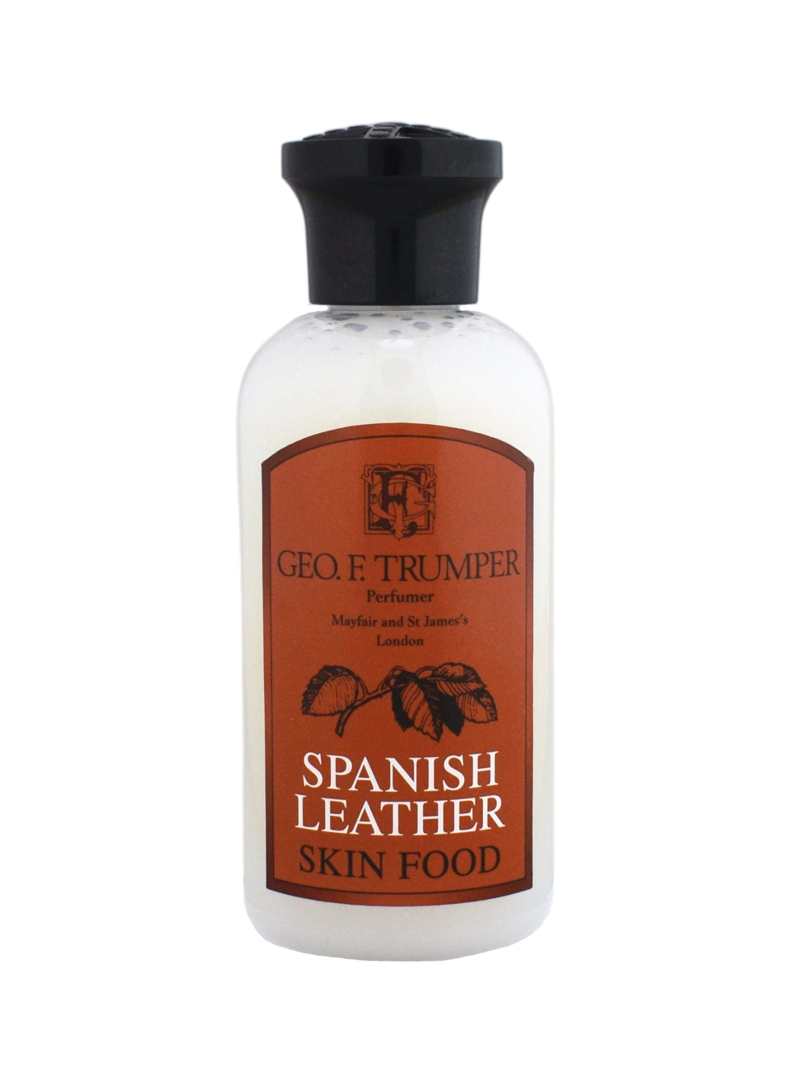 Geo. F. Trumper Spanish Leather Skin Food, ideal for gentleman’s grooming, comes in a bottle with white liquid, a black cap, and a brown label depicting text and a leafy branch illustration.