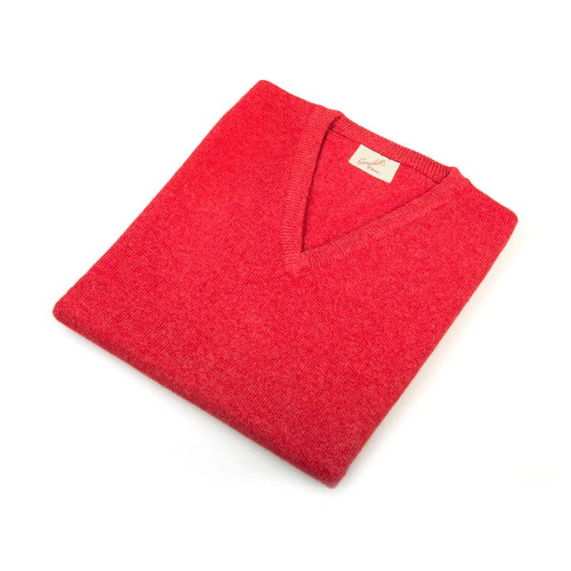 A neatly folded red Auld Stock Cashmere Slipover by Campbell's of Beauly, classic-fit knit V-neck with a visible beige label, made in Scotland and displayed on a white background.