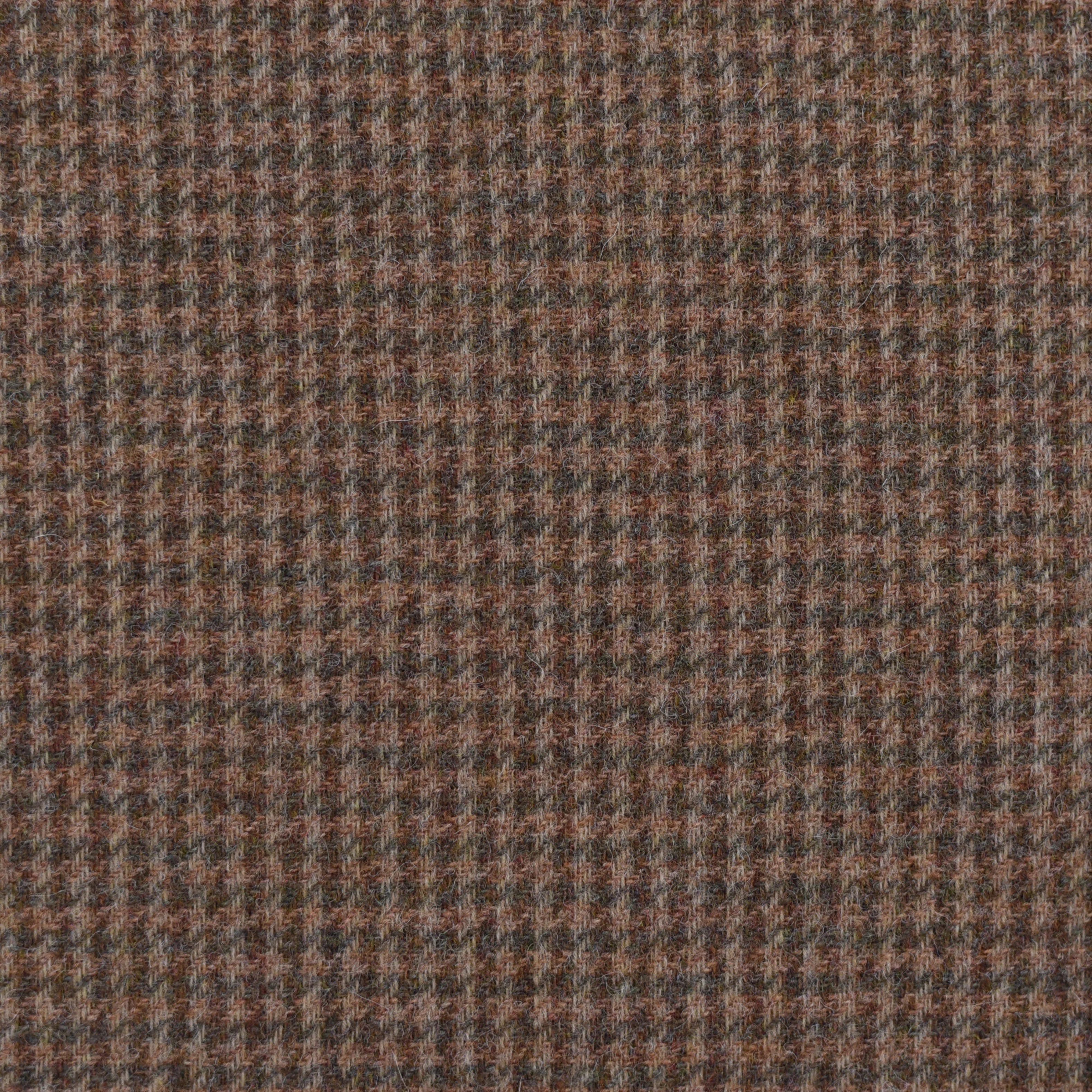 Close-up of House Tweed 11055 by Campbell's of Beauly, a brown and gray houndstooth Shetland tweed jacketing fabric with small geometric shapes for a textured, classic woven look.