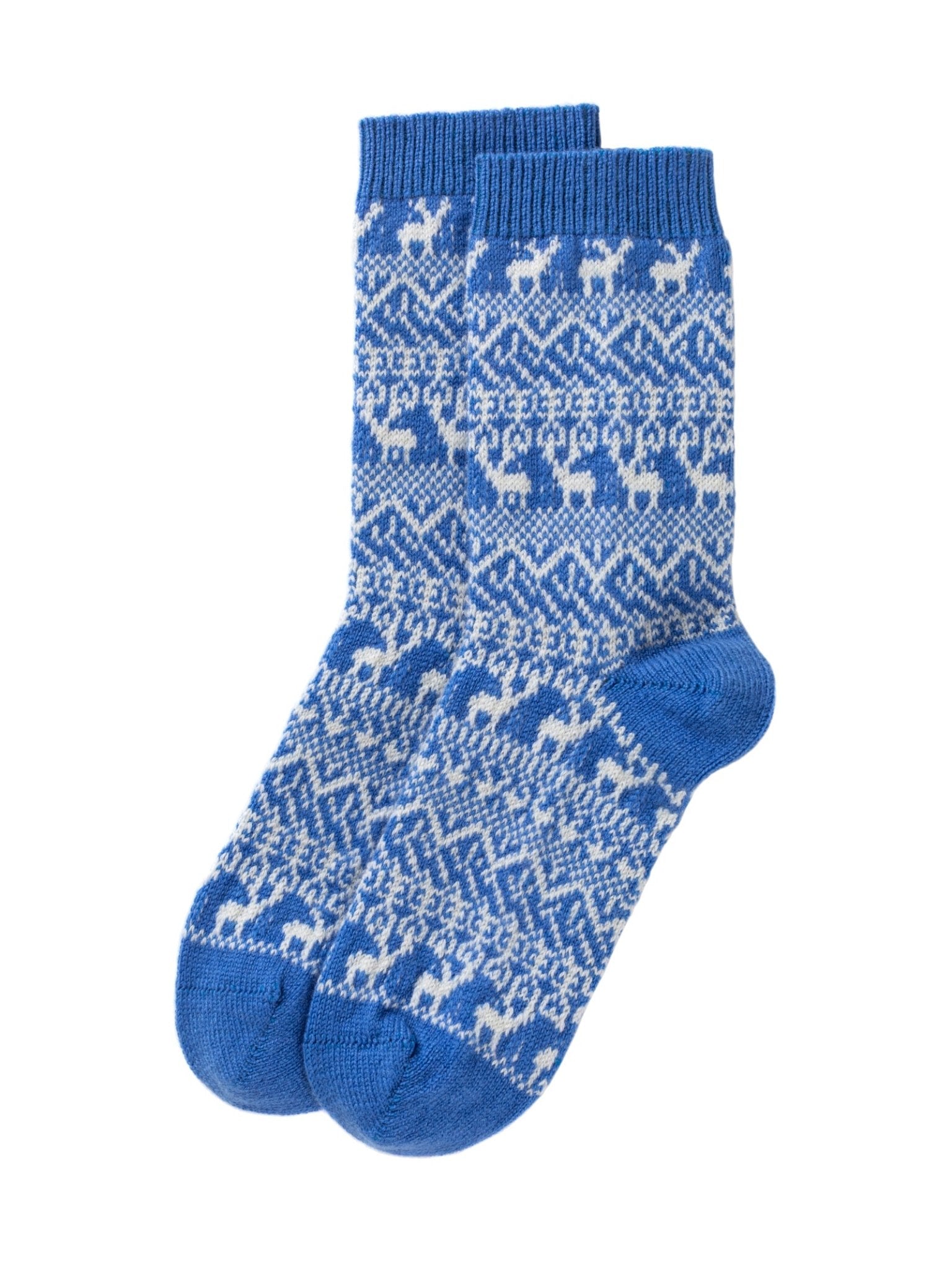 Cashmere Reindeer Socks by Campbell’s of Beauly feature a blue knit design with white reindeer and geometric patterns arranged in horizontal rows. The socks are displayed flat, with one sock overlapping the other.