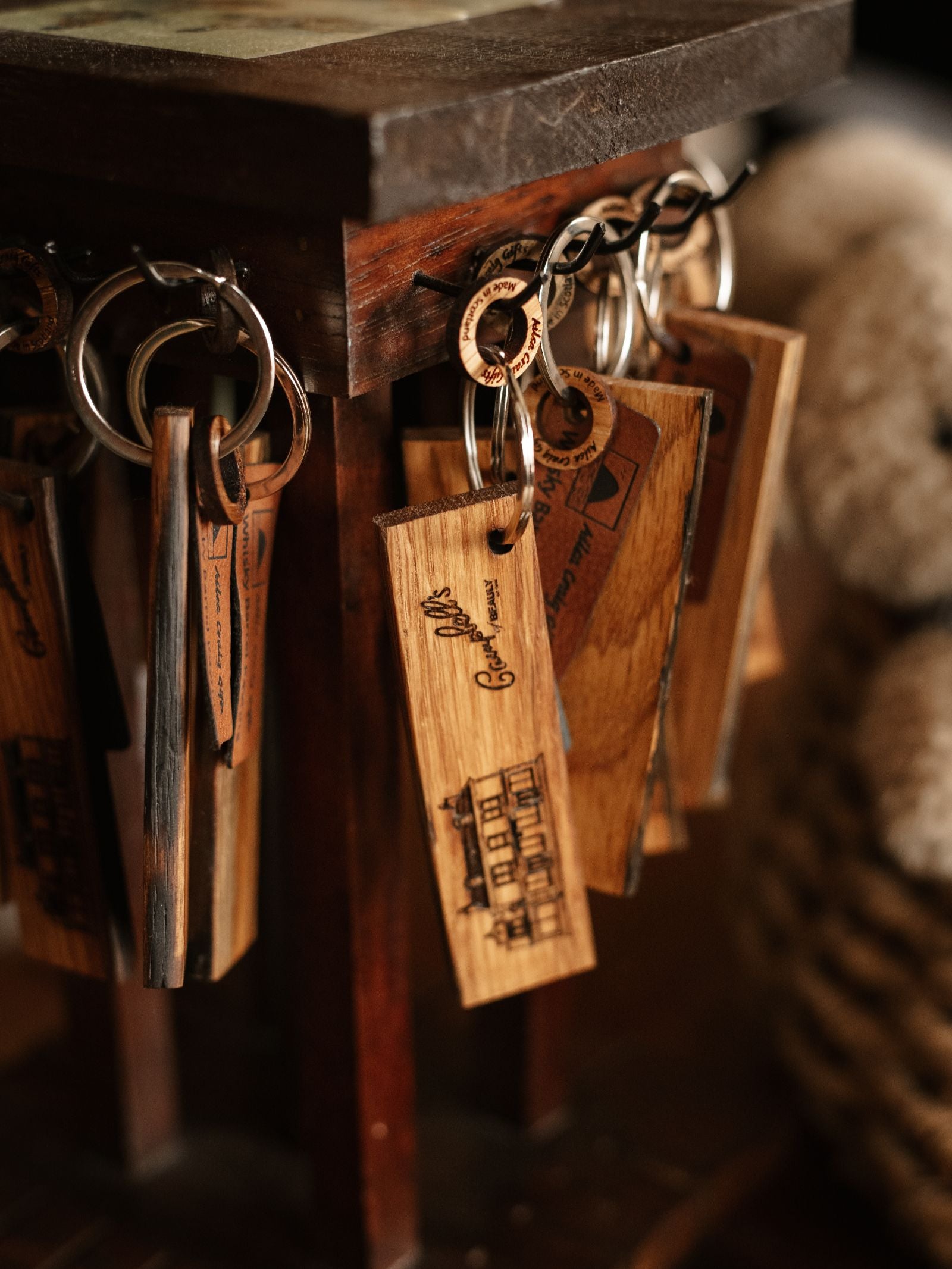 The Whisky Barrel Keyring (Beauly Store) by Campbell's of Beauly is a rectangular keyring crafted from whisky barrel oak, featuring engraved images or text and reflecting the Highland heritage of the brand.
