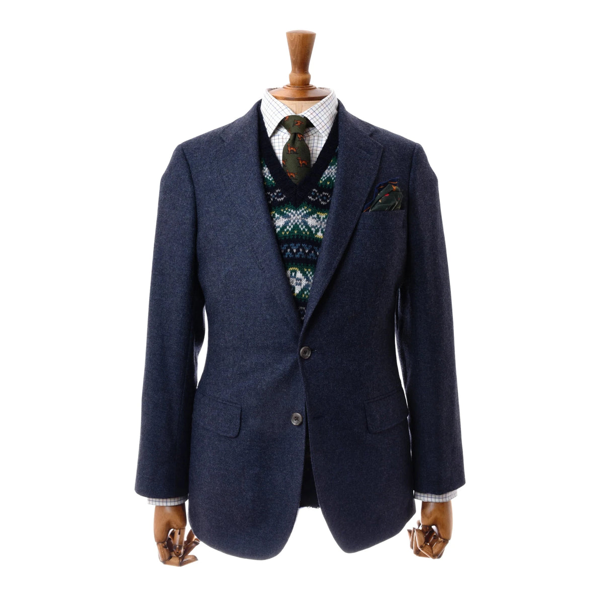 Auld Stock Navy House Jacket by Campbell’s of Beauly, shown on a wooden mannequin with a patterned sweater vest, white checkered dress shirt, patterned tie, and matching pocket square. Plain white background.