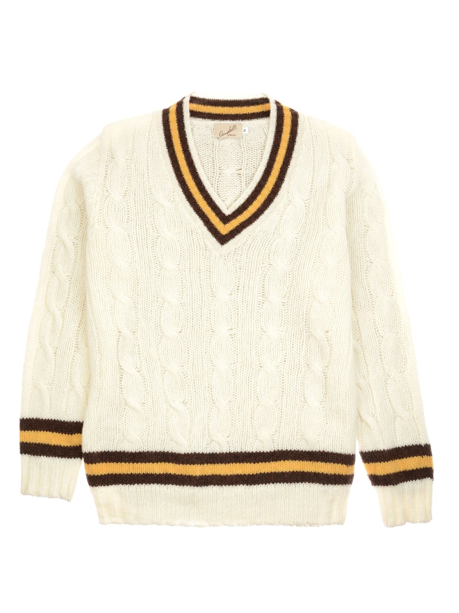 The Campbell's of Beauly Shetland Cricket Sweater is cream-colored with a V-neck and features classic cricket details, including black and yellow striped trim on the collar, cuffs, and hem.
