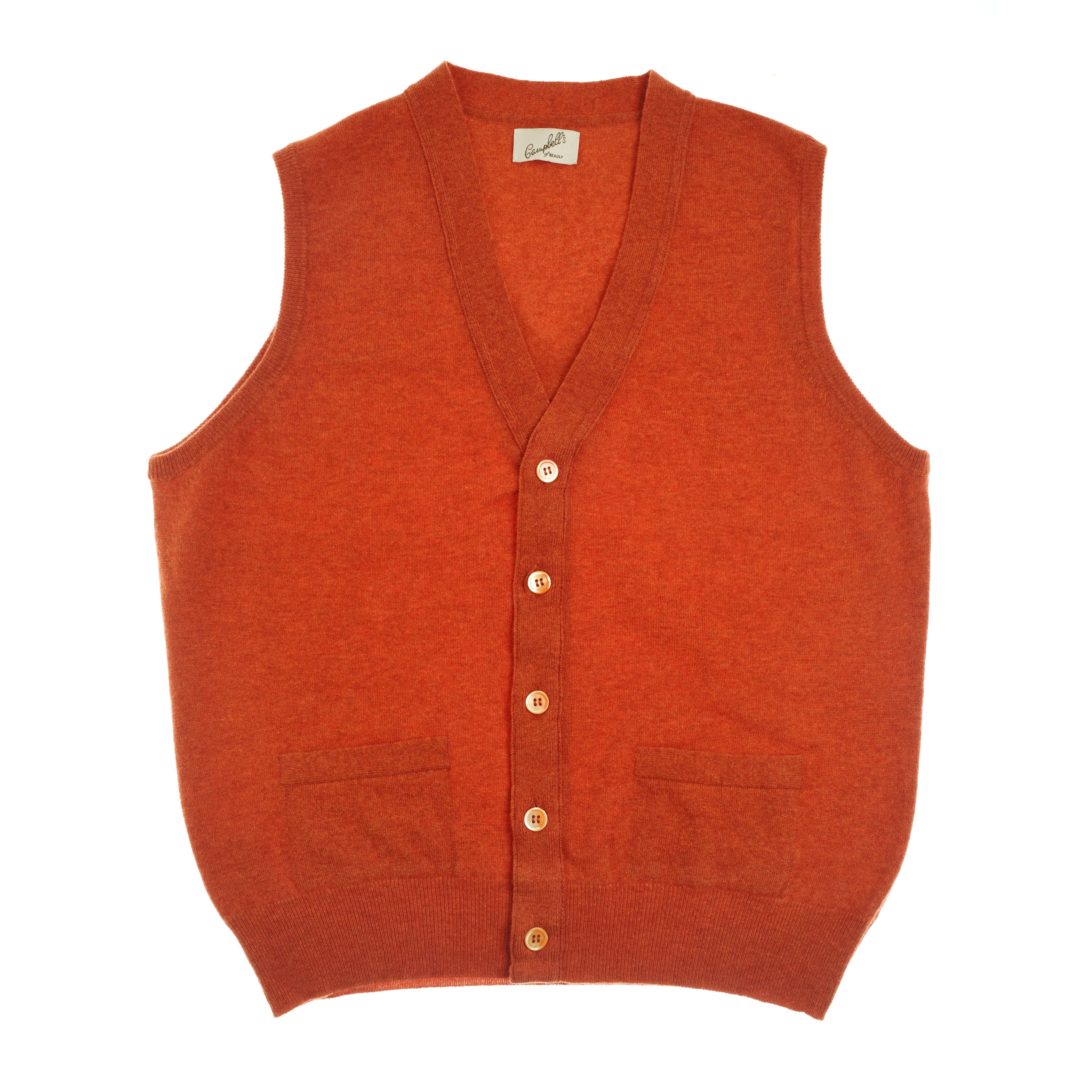 The Auld Stock Geelong Button Waistcoat by Campbell’s of Beauly is a bright orange, merino wool, waistcoat-style vest with V-neck, button-down front, and two hem pockets—perfect for adding vibrant style to your country wardrobe. Laid flat on white background.