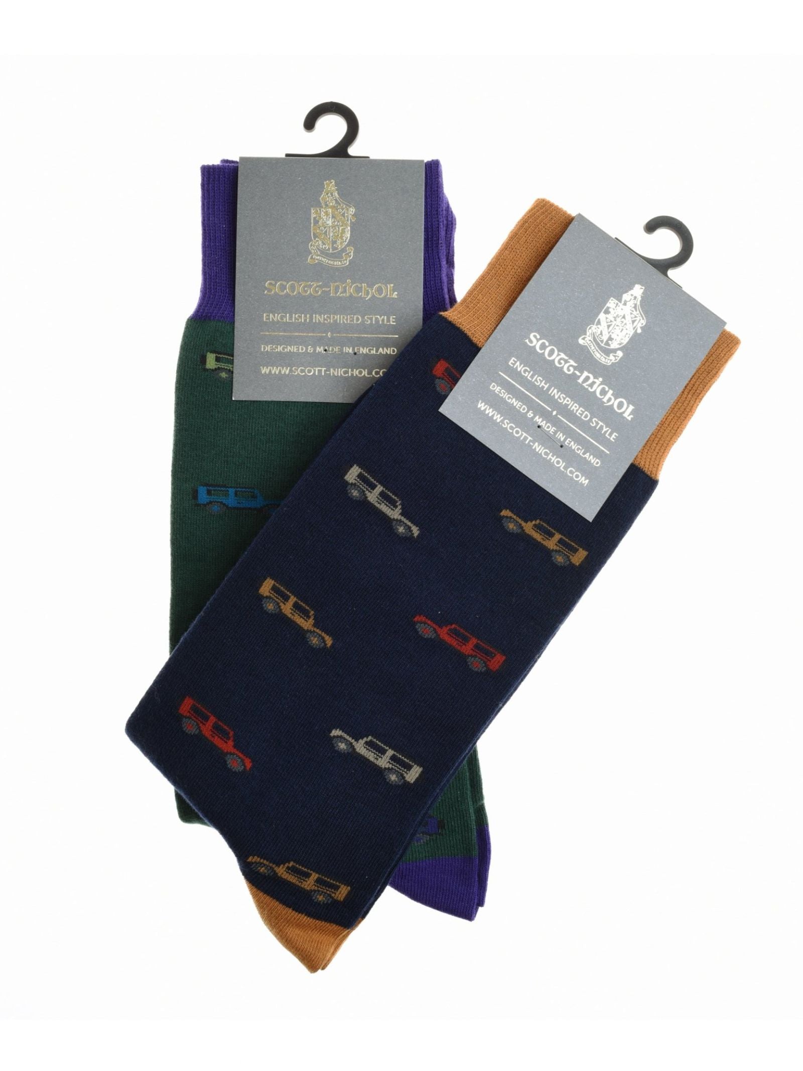 Two pairs of Campbell's of Beauly Land Rover Defender Socks—one green/purple, one navy/brown—each with colorful vintage car patterns and branded tags, make the perfect gift for Defender enthusiasts.