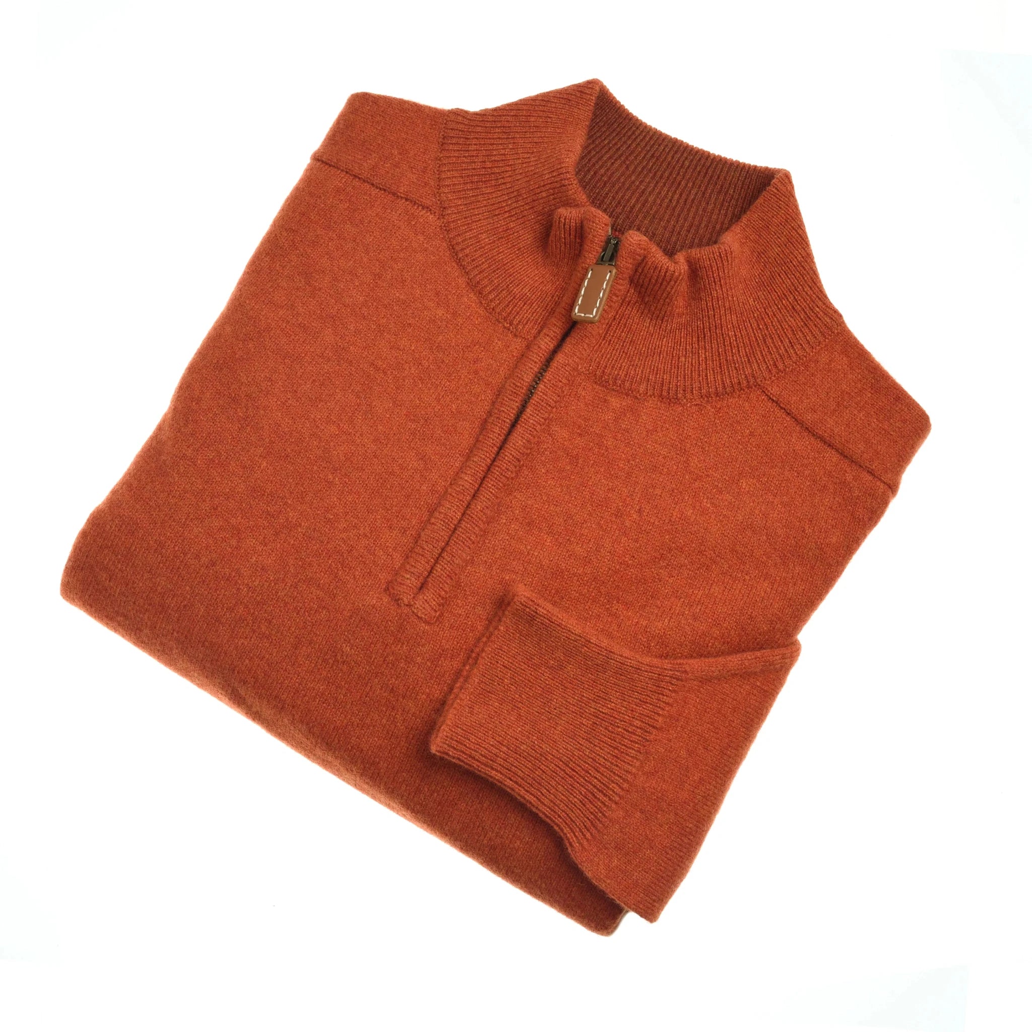 The Campbell's of Beauly Auld Stock Lambswool Quarter Zip Jumper in burnt orange, crafted from 2-ply lambswool with a stand collar and ribbed cuffs, is shown folded on a white background.