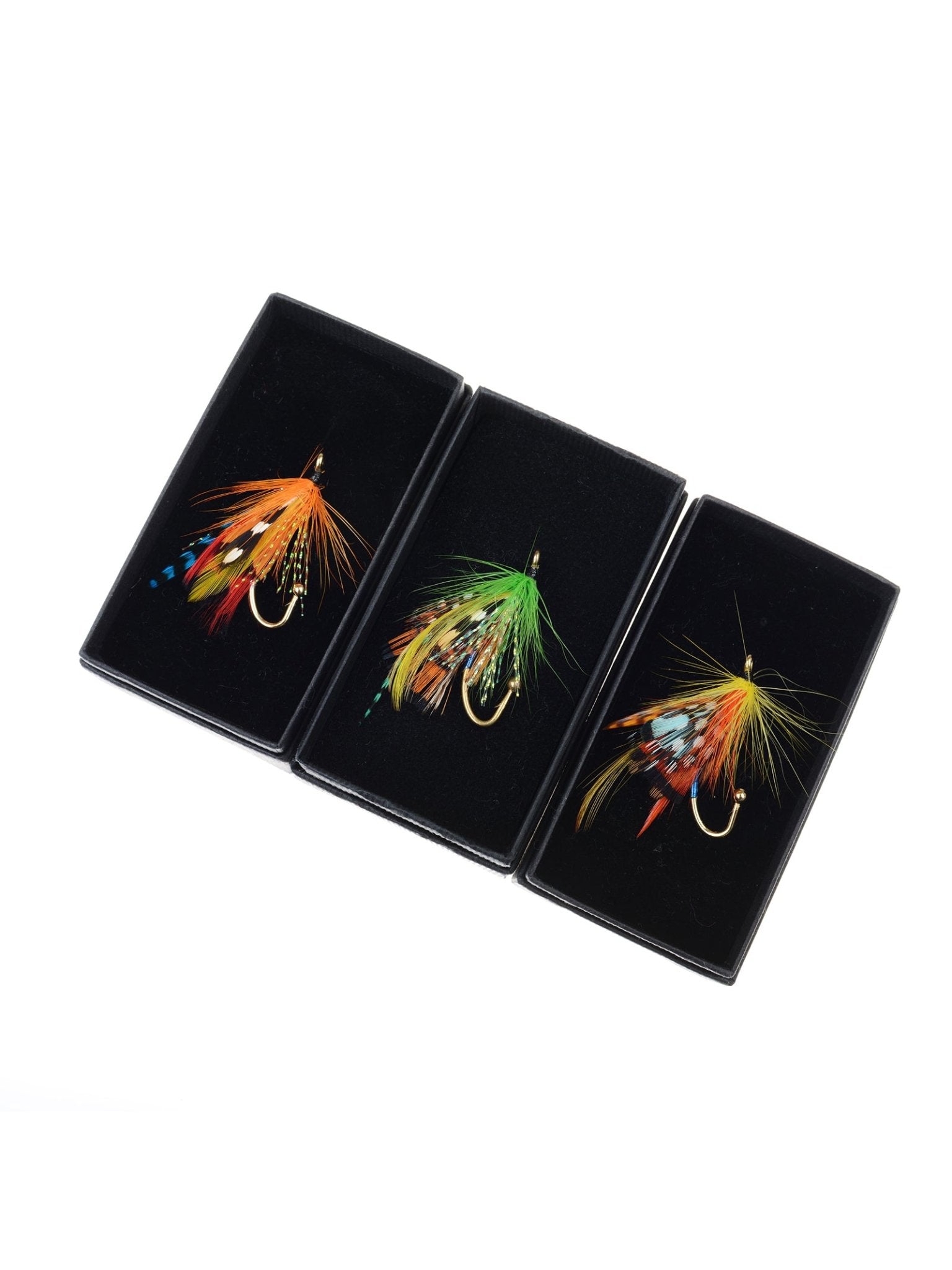 Three Campbell's of Beauly Fly Fishing Brooches are displayed in black boxes on a white background, featuring handmade accents in orange, green, and blue feathers for unique country style.