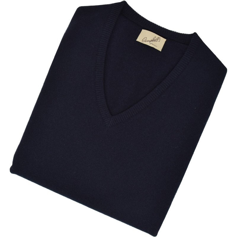 The Campbells of Beauly Cashmere Slipover in navy, shown neatly folded with a beige neck label on a white background, is a timeless V-neck sweater inspired by the Scottish Borders’ heritage.