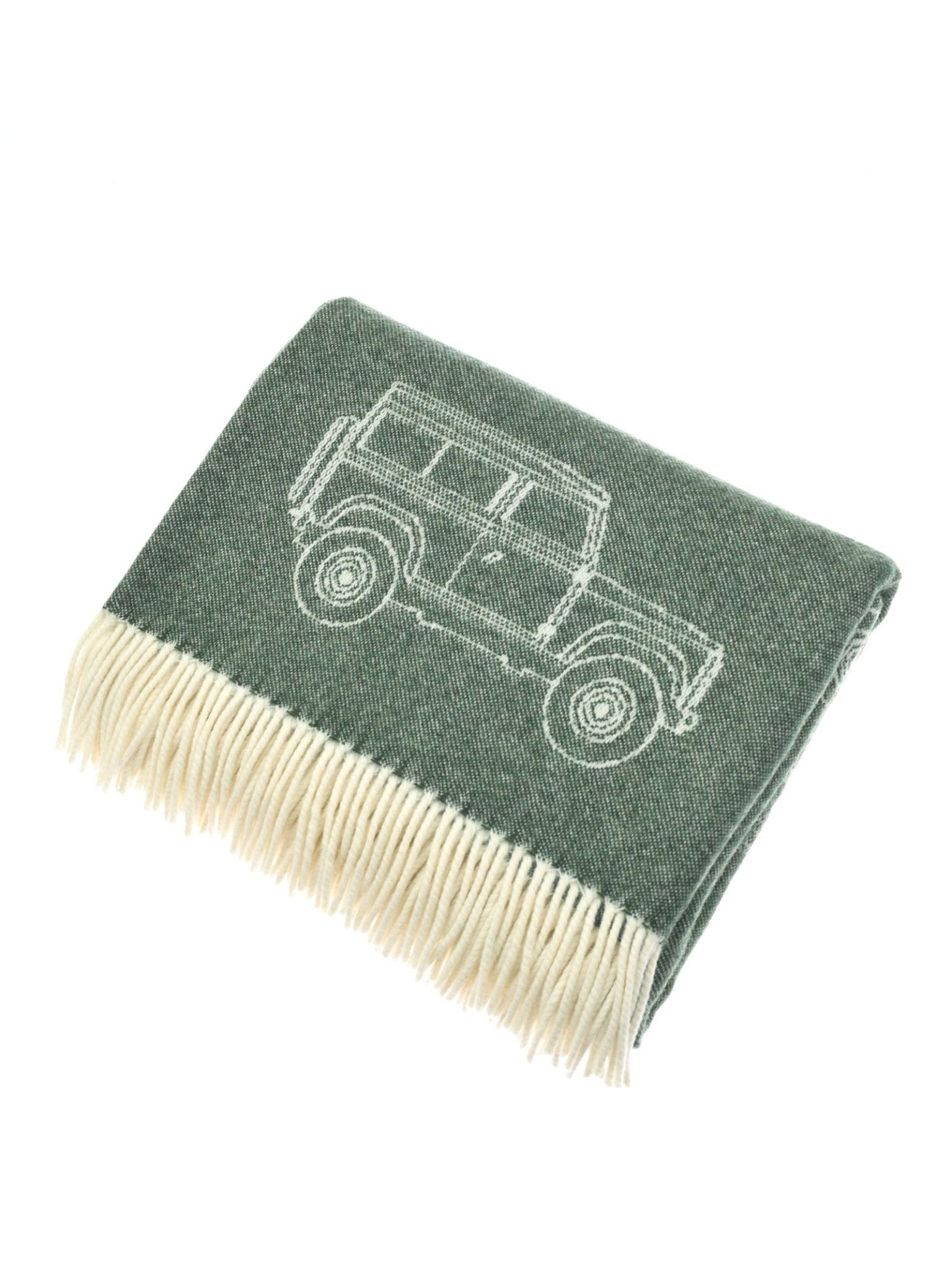 The Campbell's of Beauly Land Rover Defender Jacquard Throw is a green British-made throw with cream fringe, featuring an outline of an SUV.