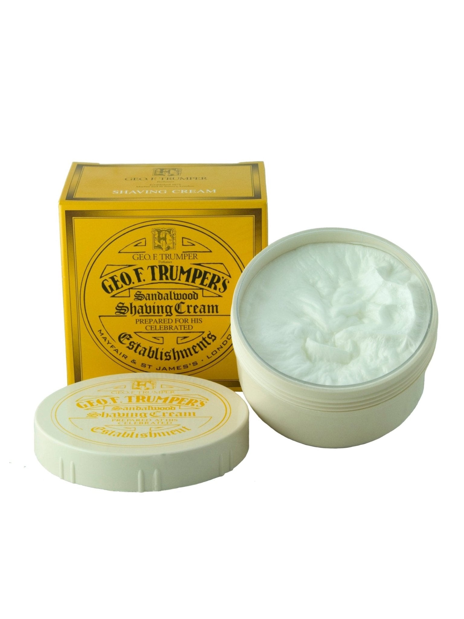 A yellow box and an open white tub of Geo. F. Trumper Sandalwood Shaving Cream, with the lid showing the brand's logo and rich glycerine-based cream inside, ideal for sensitive skin.