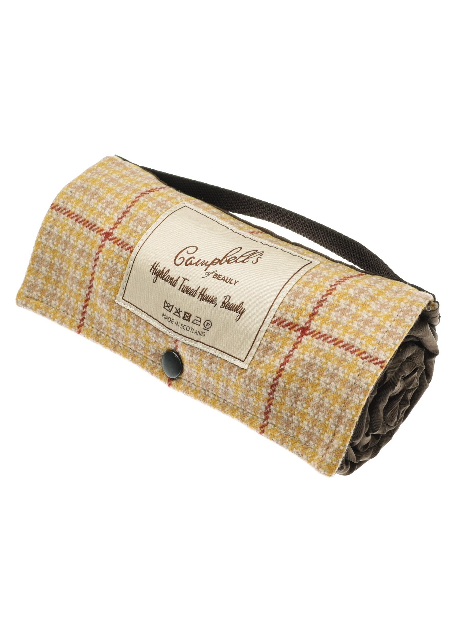The Walker Camper Picnic Rug by Campbell's of Beauly features a yellow and red plaid design in British wool, secured with a black button strap. A front label reads “Campbell’s Highland Tweed House Beauty.”.