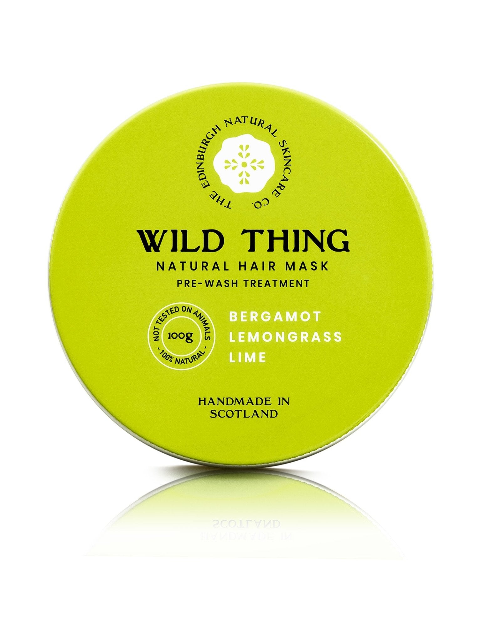 A round, lime-green tin labeled “Wild Thing Natural Hair Conditioner.” Handmade in Scotland by Edinburgh Natural Skincare Co., this conditioner uses natural butters with bergamot, lemongrass, and lime to help restore damaged hair.