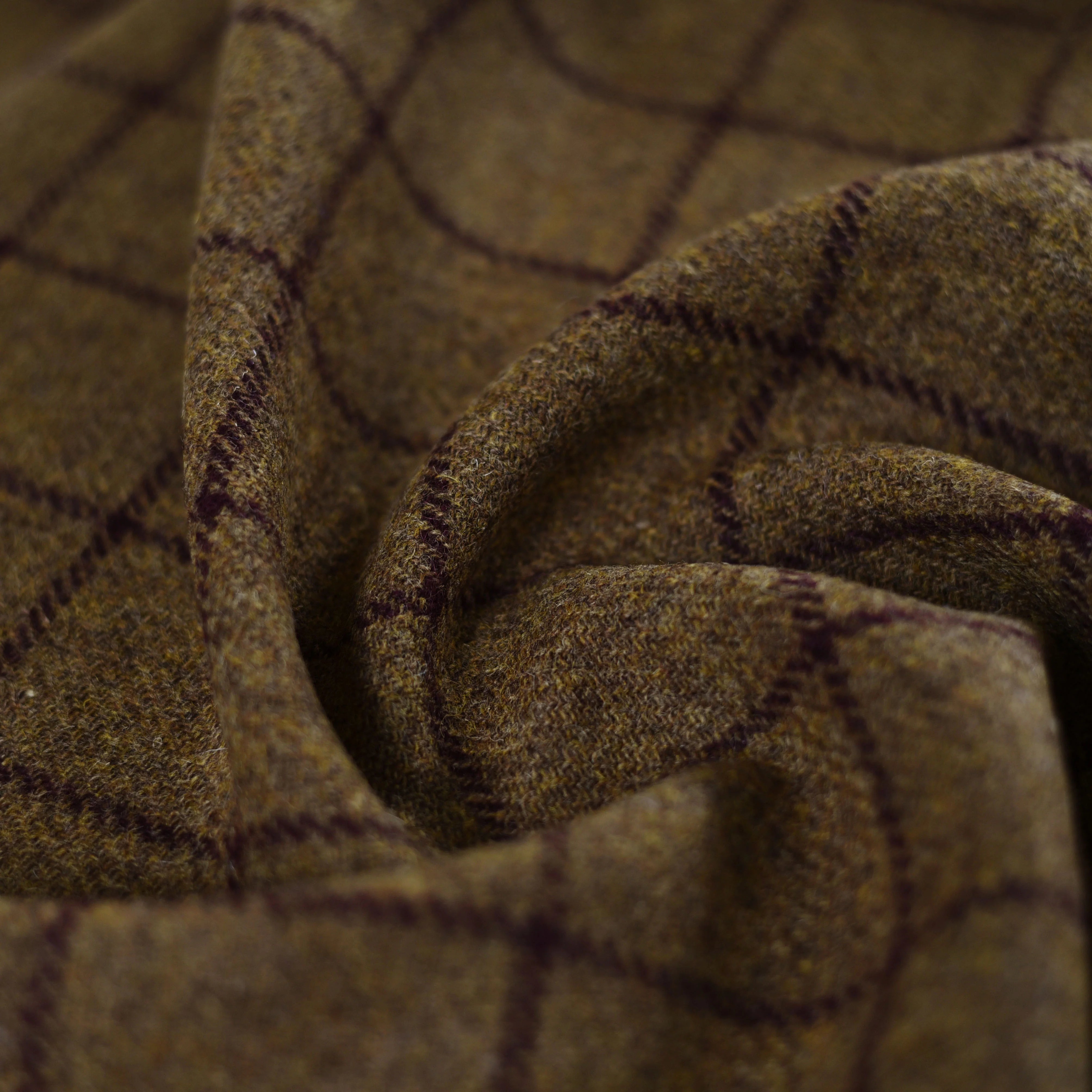 Close-up of Harris Tweed 79367 by Campbell's of Beauly—brown wool with a dark checkered pattern, soft texture, and gentle folds—reflecting classic craftsmanship and Scottish heritage.