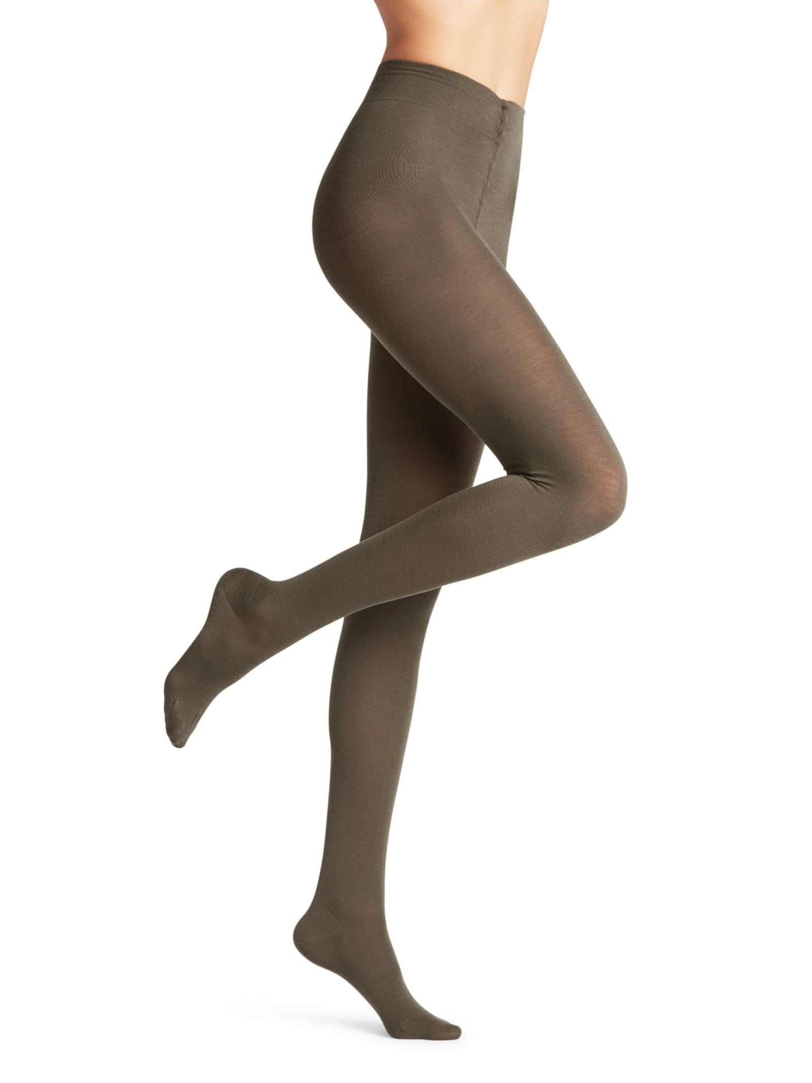 Model wearing FALKE Merino Tights in opaque olive-green, with one leg bent and foot pointed—ideal for stylish looks and natural temperature regulation.