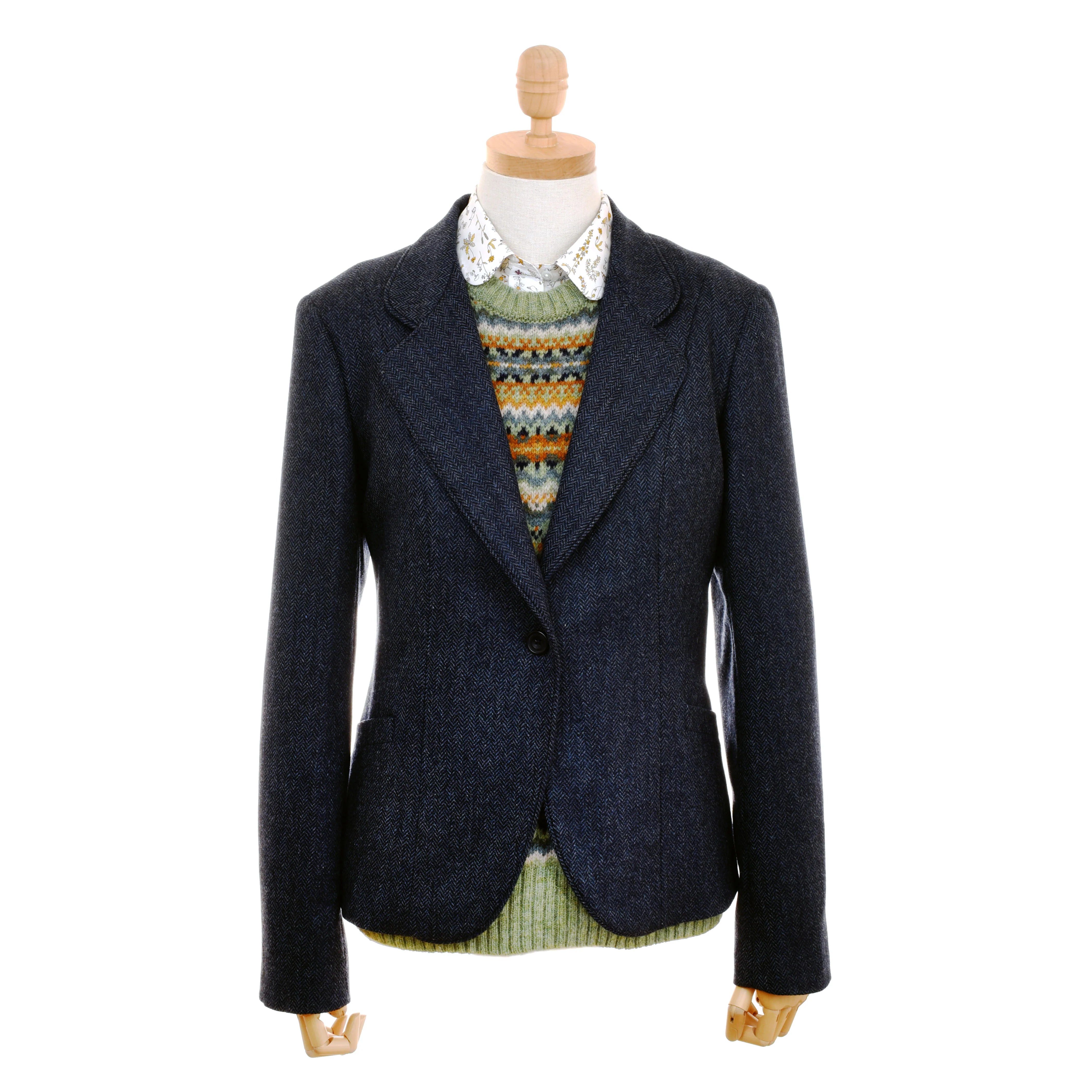 A mannequin showcases the Auld Stock House Jacket by Campbell's of Beauly over a multicolored sweater and a white floral-collared shirt, all arranged neatly against a white background.