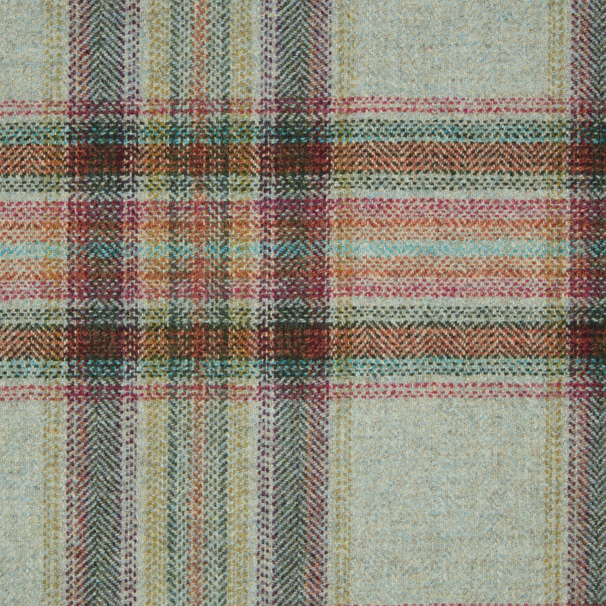 A close-up of Campbell's of Beauly House Tweed 82206, a classic wool tailoring fabric woven in England with red, green, yellow, blue, and brown tartan stripes on light beige. The weave and texture are prominently displayed.