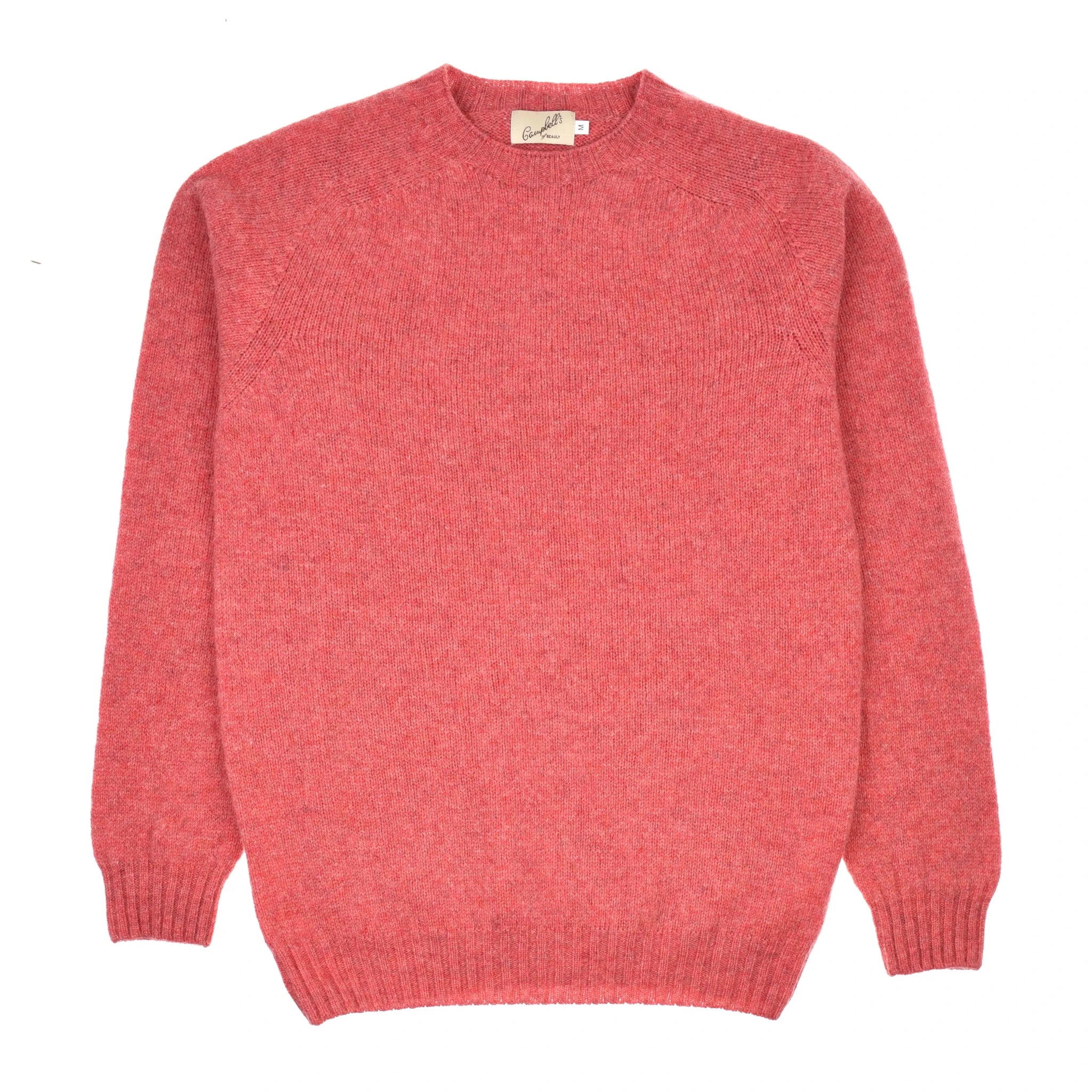 The Campbell's of Beauly Shetland Jumper is a plain, long-sleeved crew neck lambswool sweater in soft pinkish-red with ribbed cuffs, collar, and hem, shown laid flat on a white background.