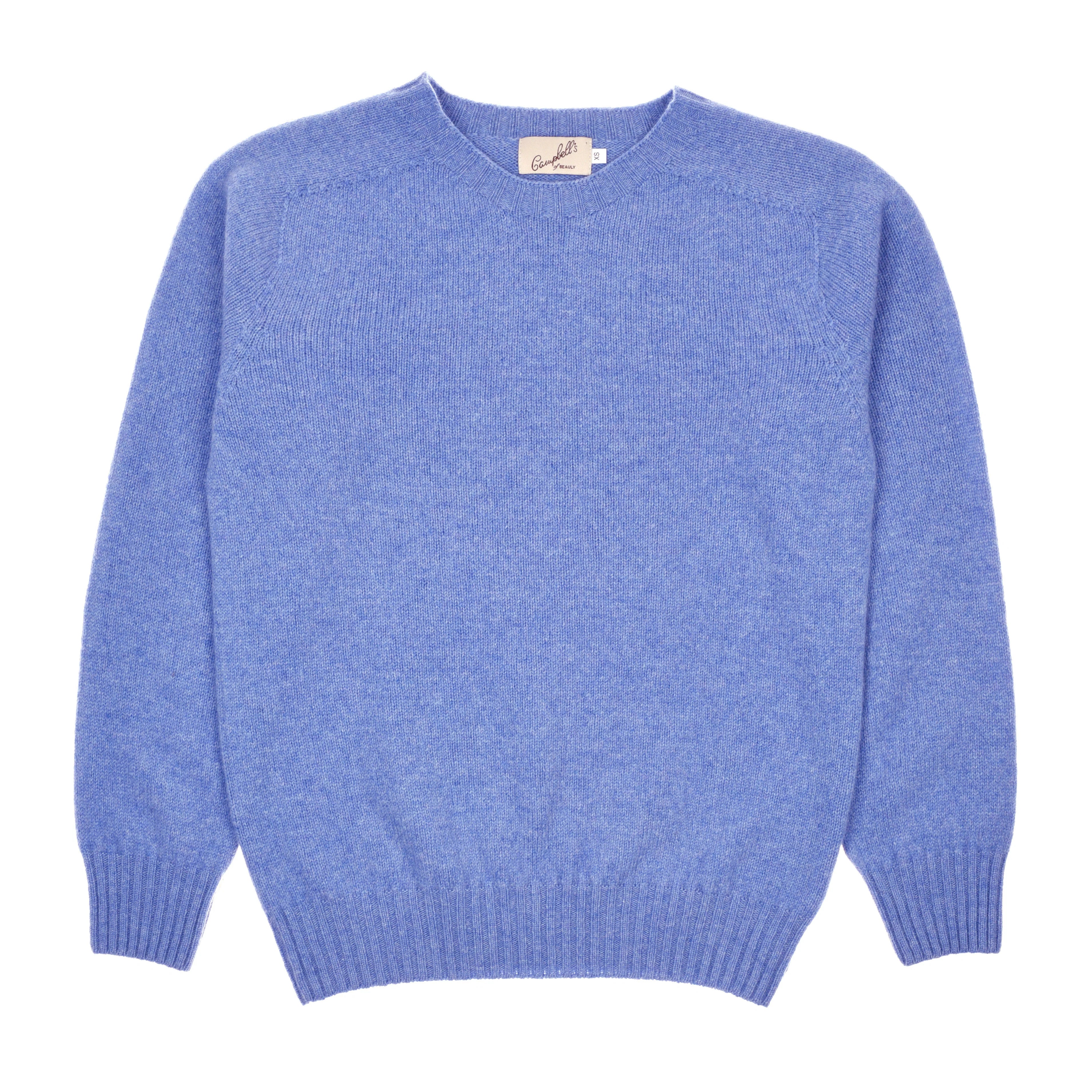 The Campbell's of Beauly Auld Stock Geelong Lambswool Crew Neck Jumper in light blue, featuring long sleeves and a fine Scottish knit, is shown laid flat on a white background.