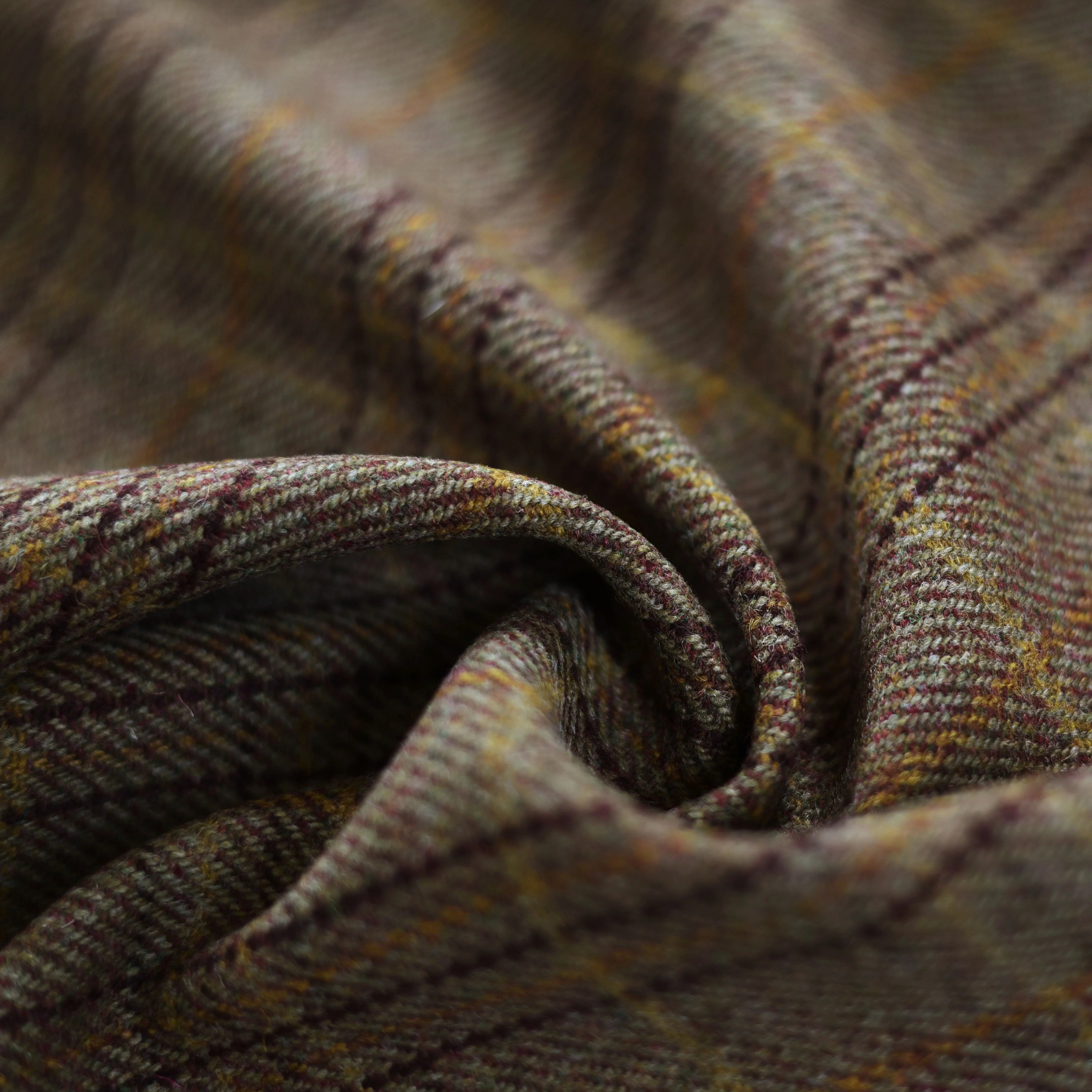 Close-up of Campbell's of Beauly House Tweed 30248: a heavyweight Scottish wool tweed in brown and olive plaid, finely lined and softly folded to display its classic Estate Tweed texture and pattern detail.