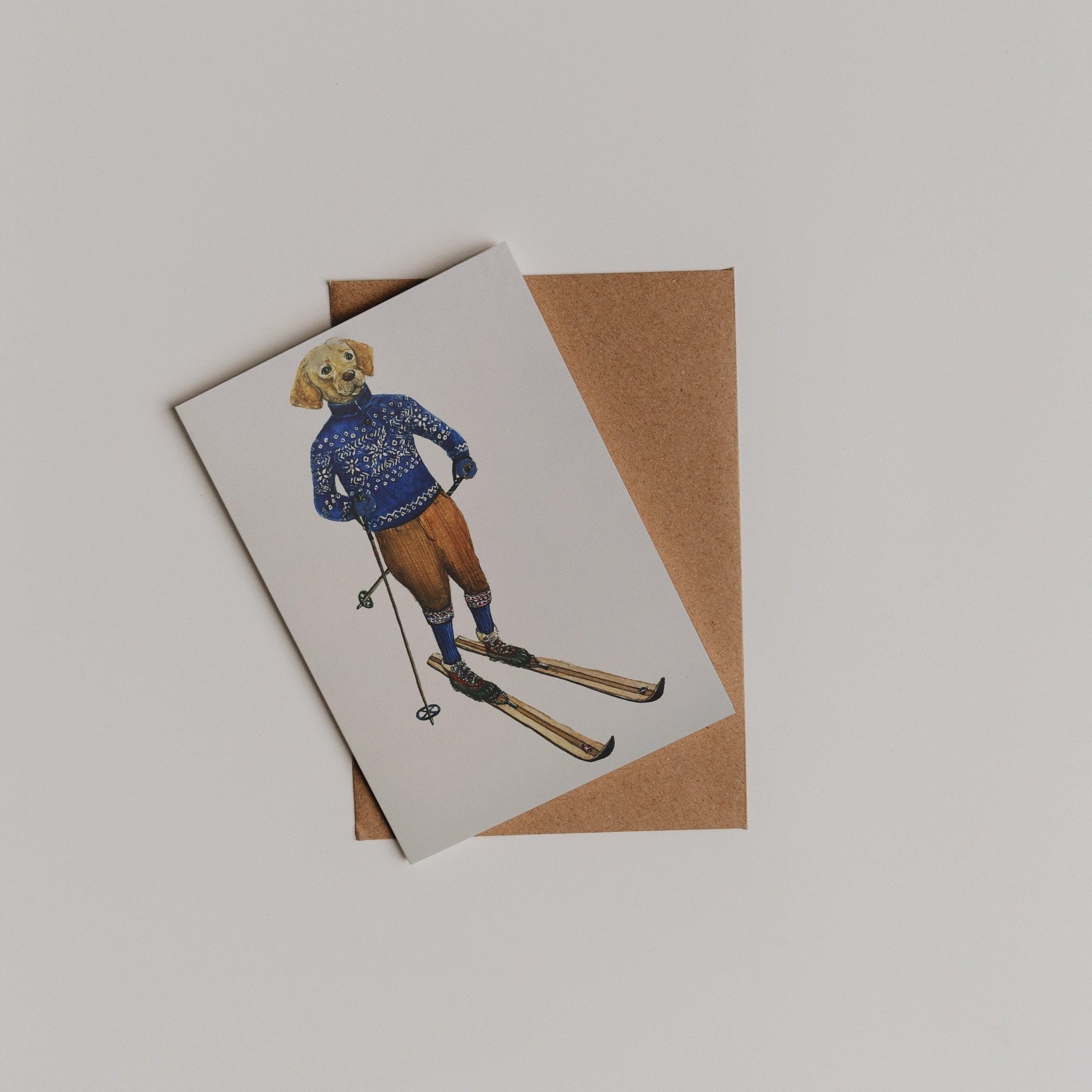 The Alpine Highlander Greeting Card by Campbell's of Beauly features a Sophie Murray illustration of a dog in winter clothes skiing, placed atop a brown envelope—a charming choice for your thank you note.