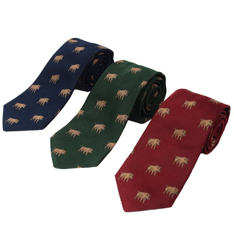 Three rolled Boar Silk Ties by Campbells of Beauly in navy, forest green, and burgundy, each adorned with a subtle repeating brown bull embroidery—a refined countryside touch.