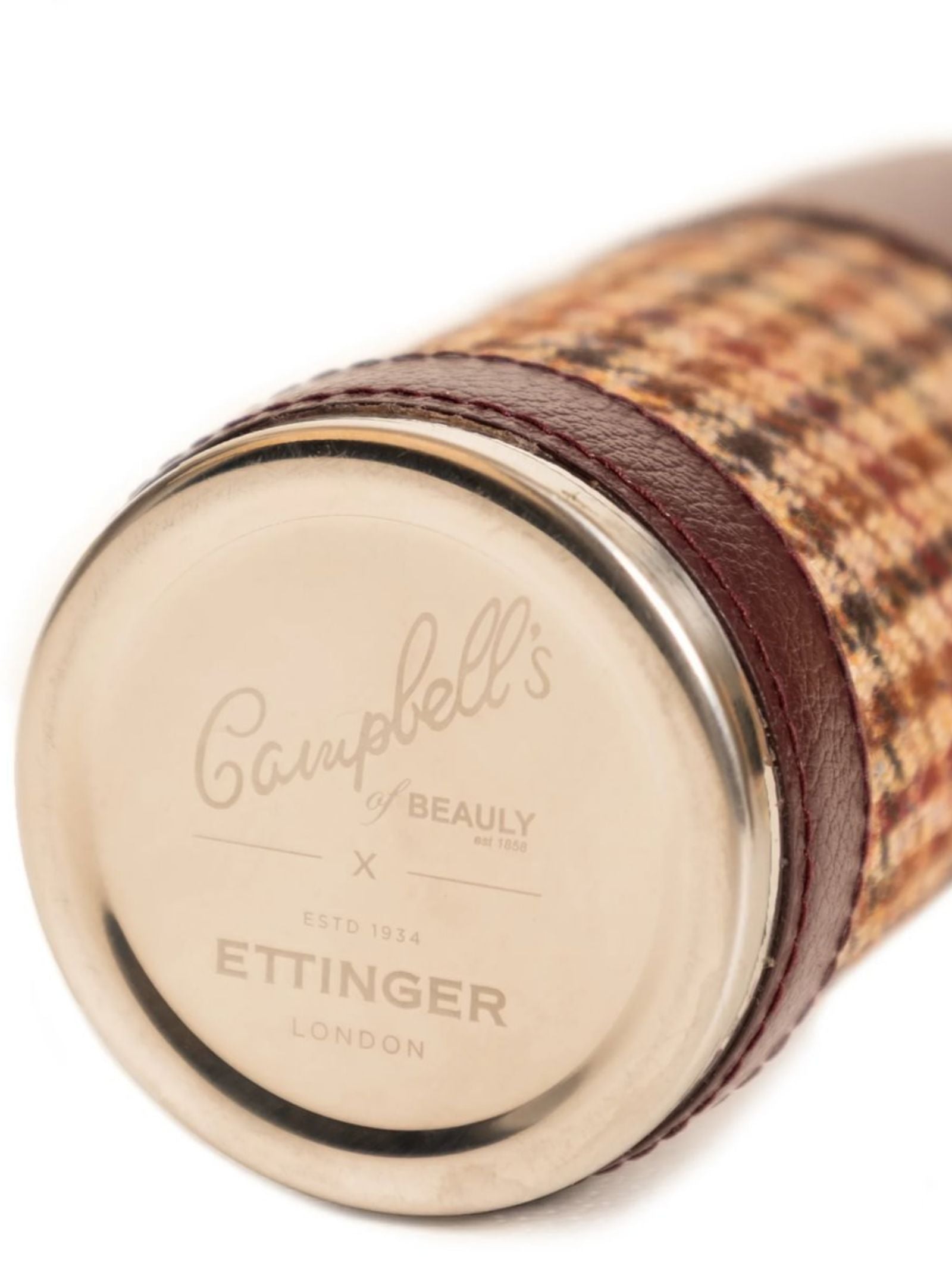 A close-up of the 8oz Bordeaux Hunter Flask by Campbell's of Beauly x Ettinger, wrapped in brown, tan, and cream plaid with brown Capra goat leather trim and a metal end—an elegant example of British craftsmanship.