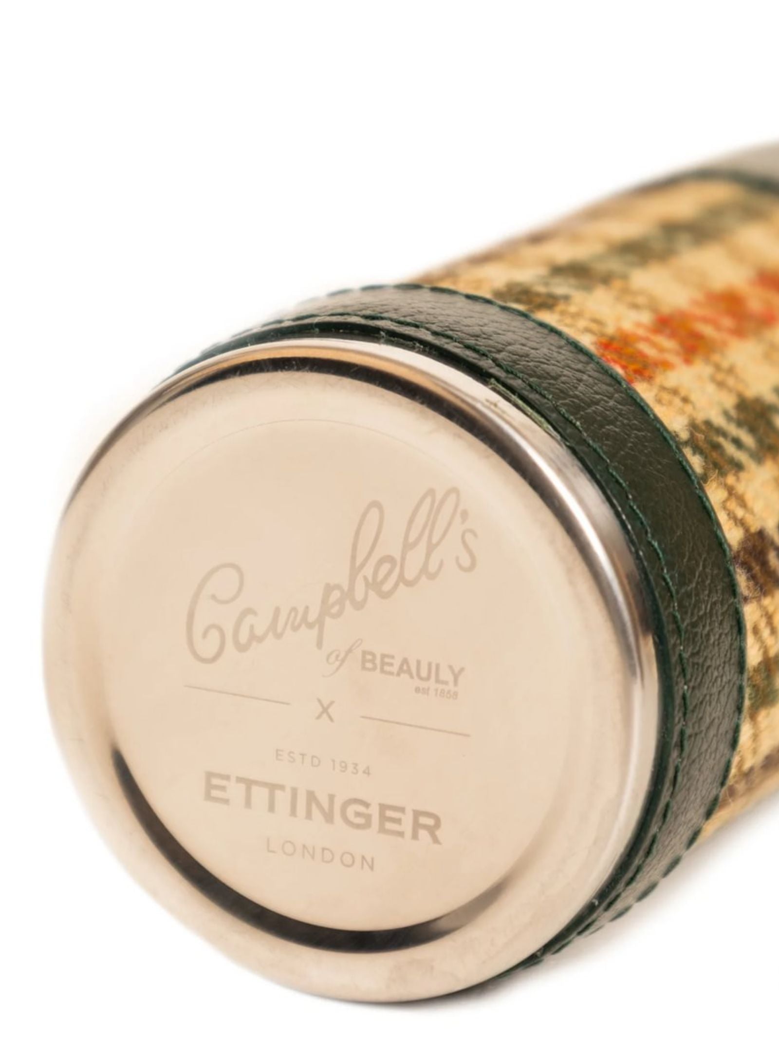 A close-up of the 8oz Forest Green Hunter Flask by Campbell's of Beauly x Ettinger showcases British craftsmanship, with tartan fabric, dark green Capra leather, and an engraved metal end cap.