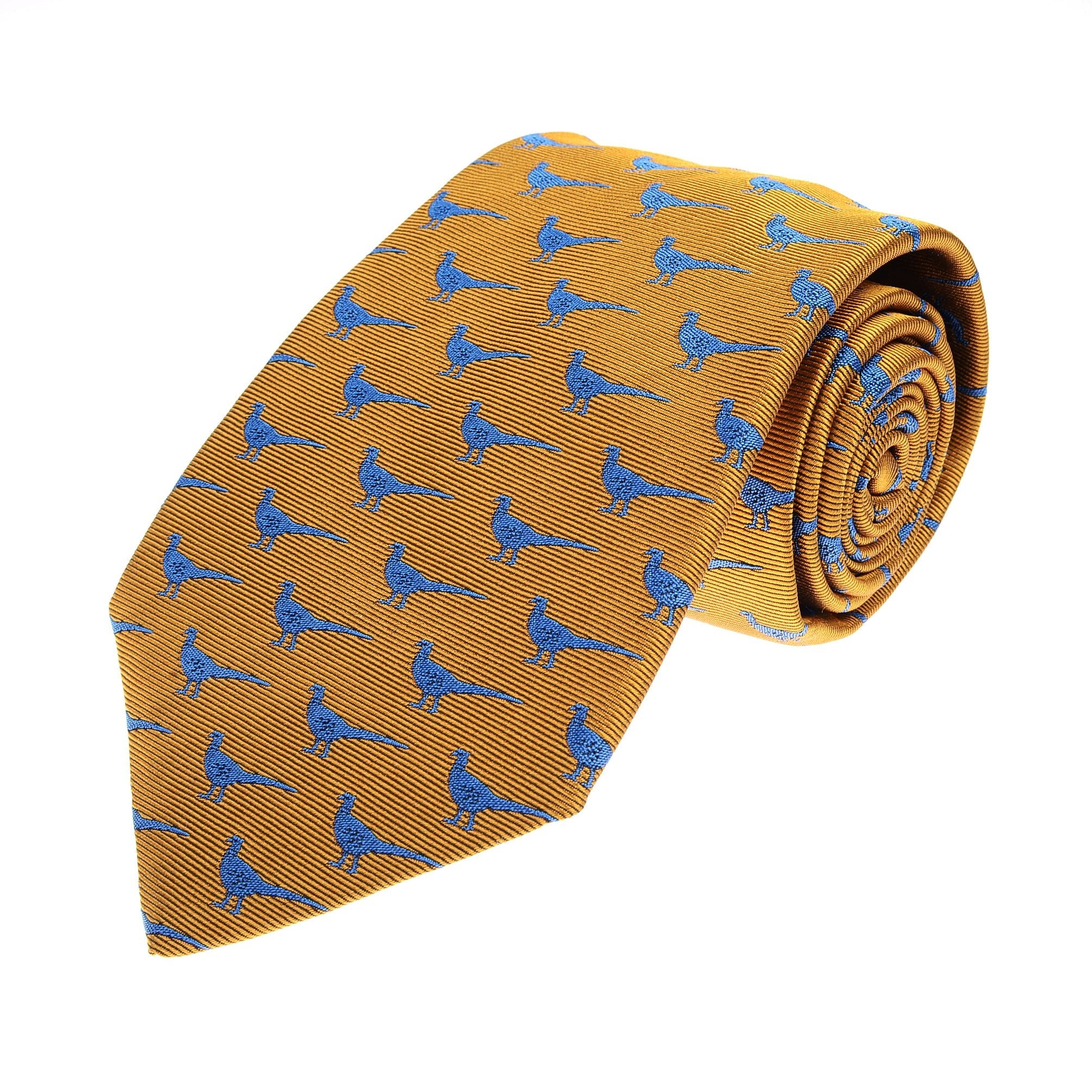 The Campbells of Beauly Pheasant Silk Tie in gold features a handmade design with a subtle pheasant motif and small blue birds, making it an elegant accessory for any tie collection. Shown rolled at one end against a white background.