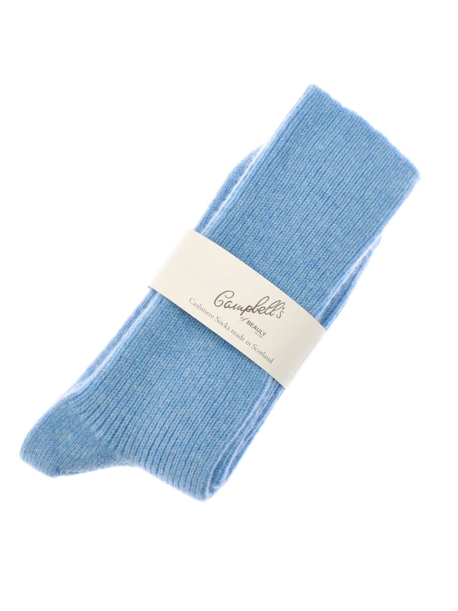 A pair of Violet Blue Plain Cashmere Socks by Campbells of Beauly, neatly folded with a branded cream label, made in the Scottish Borders. Displayed on a white background, they make an ideal luxury gift.