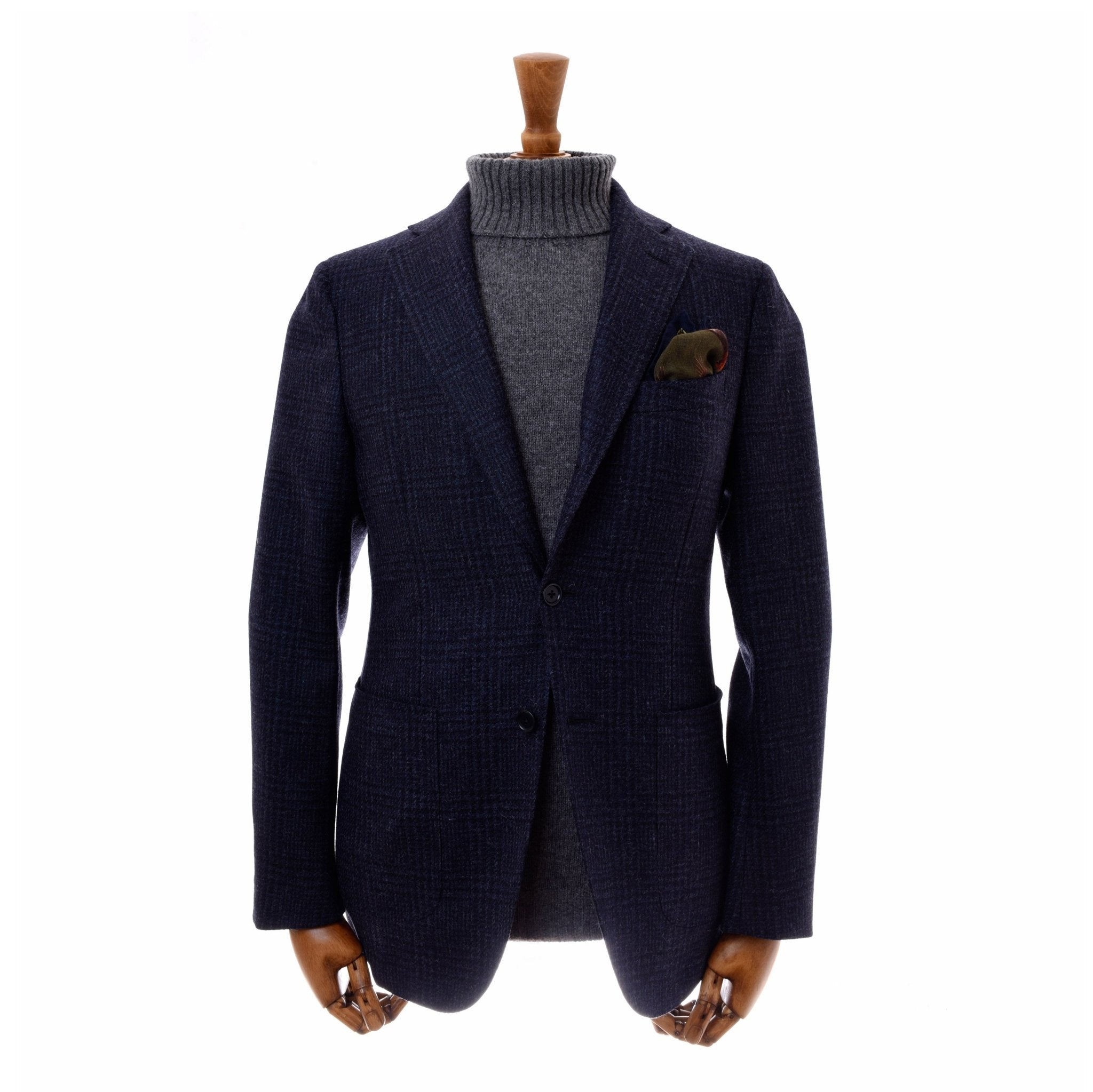 A mannequin showcases Campbell's of Beauly's Auld Stock Glen Check Jacket with an unstructured silhouette over a gray turtleneck and pocket square, set against a white background.