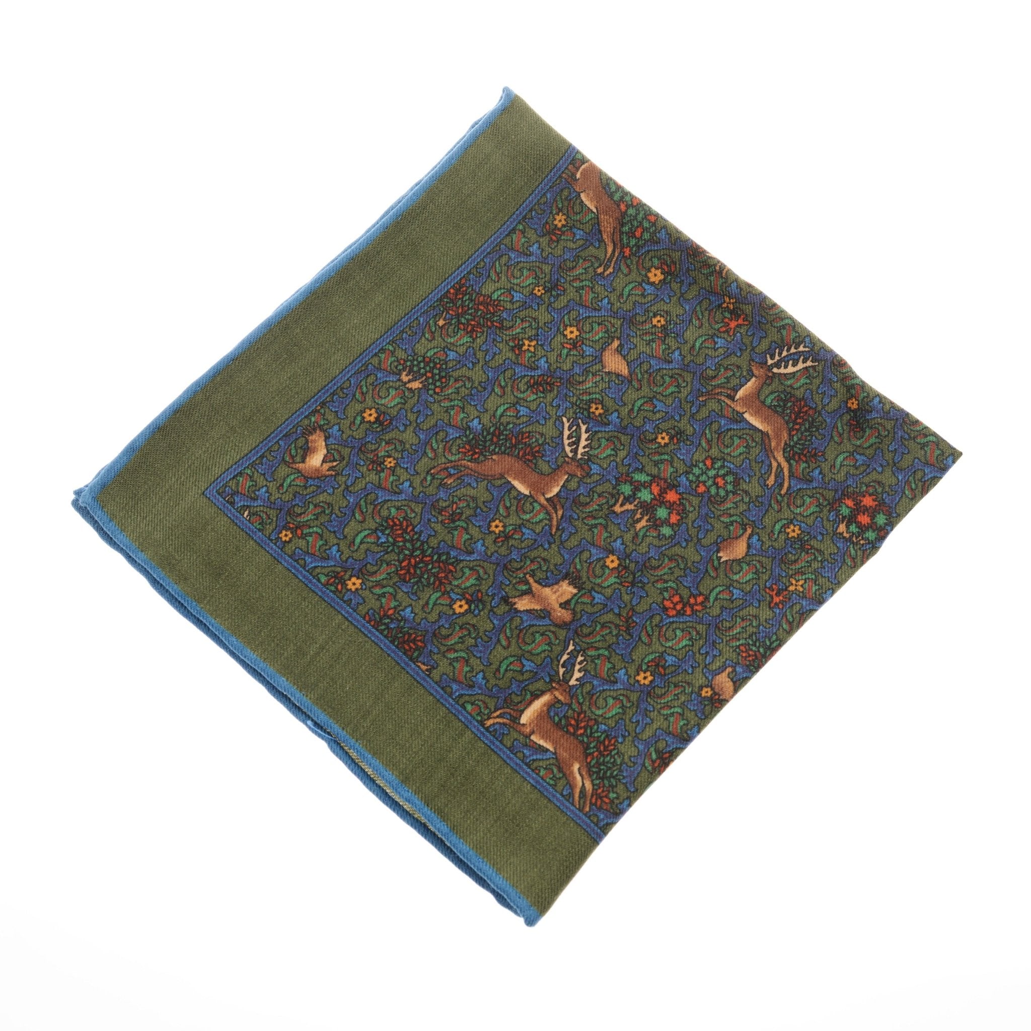 A timeless accessory, the Campbells of Beauly Wool Hank in green has hand-rolled edges and a detailed deer and foliage pattern in blue, green, and brown.