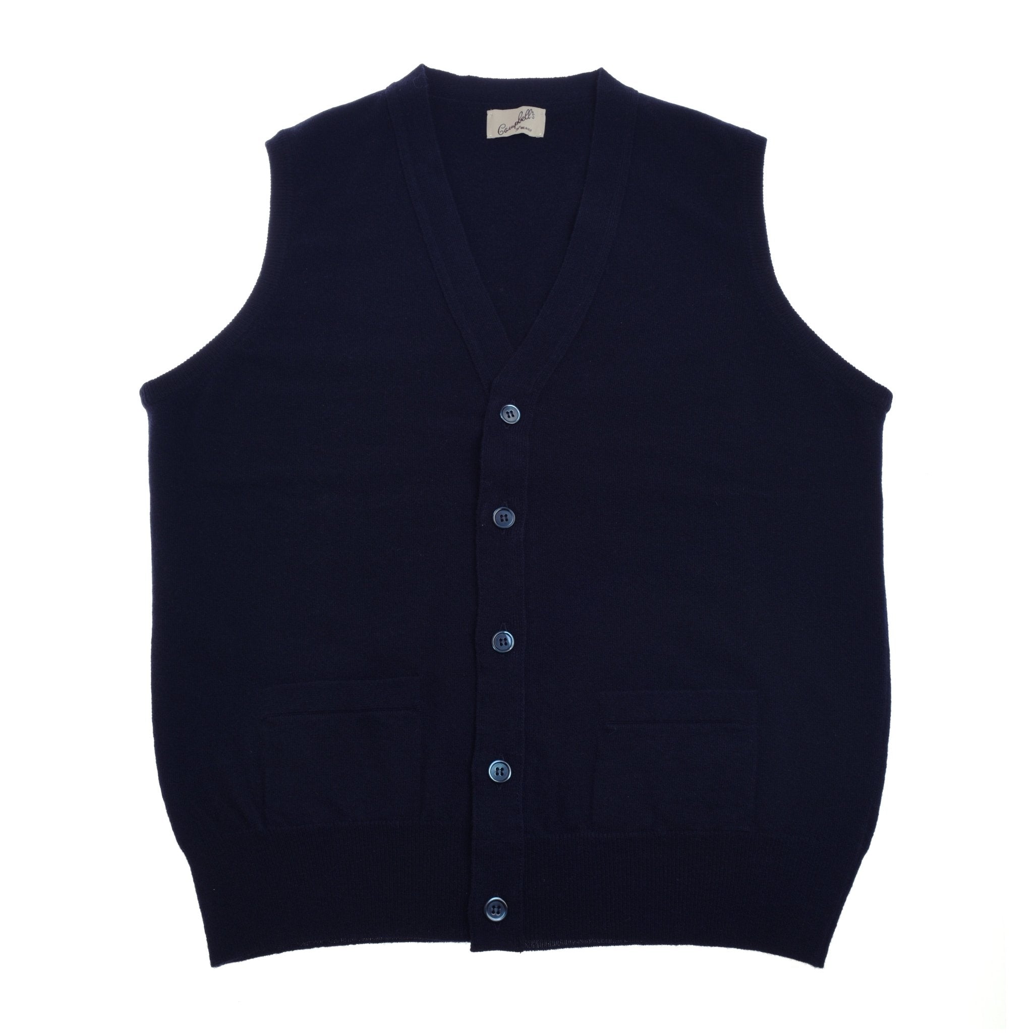 The Geelong Button Waistcoat by Campbell's of Beauly is a navy blue, sleeveless merino wool knit vest with a V-neck, button front, and two pockets, shown laid flat on a white background.