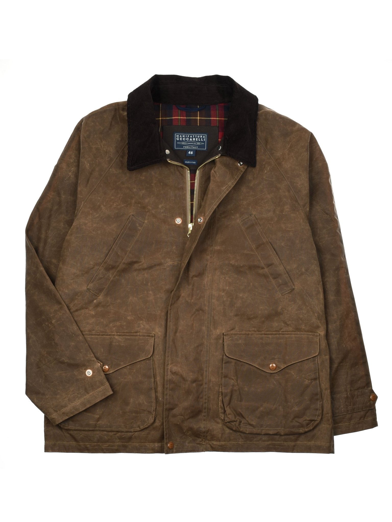 Experience heritage outerwear at its finest with the Rain Cabaan Jacket by Campbell’s of Beauly. Crafted in brown waxed cotton, this jacket boasts a dark corduroy collar, a front zipper with snap button closures, two spacious front flap pockets, and a distinctive plaid lining peeking out at the collar. The Rain Cabaan is shown laid flat on a white background to showcase its timeless details.