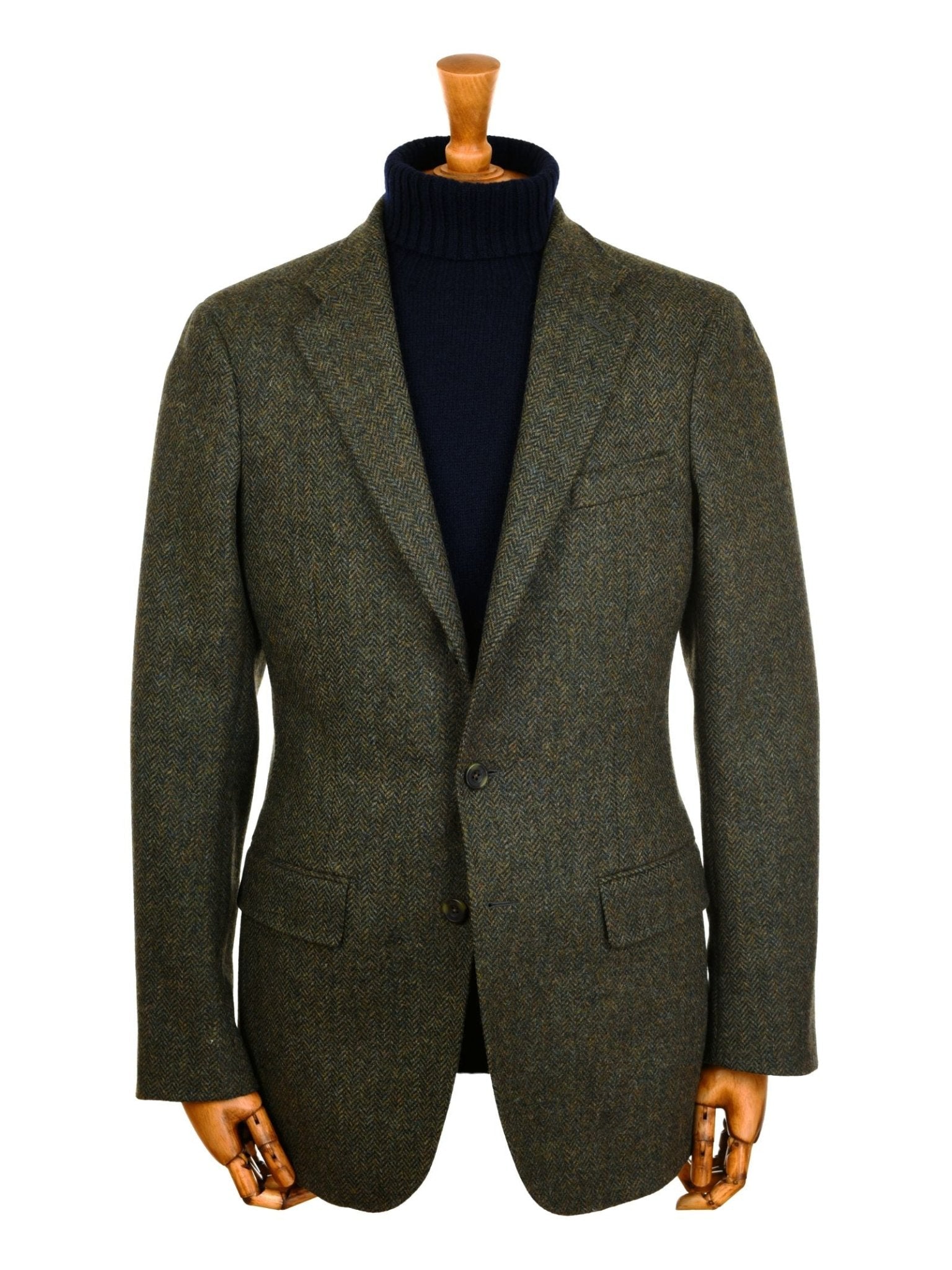 Campbell's of Beauly Green Herringbone House Jacket styled with a navy turtleneck, shown on a mannequin with wooden hands against a white background.