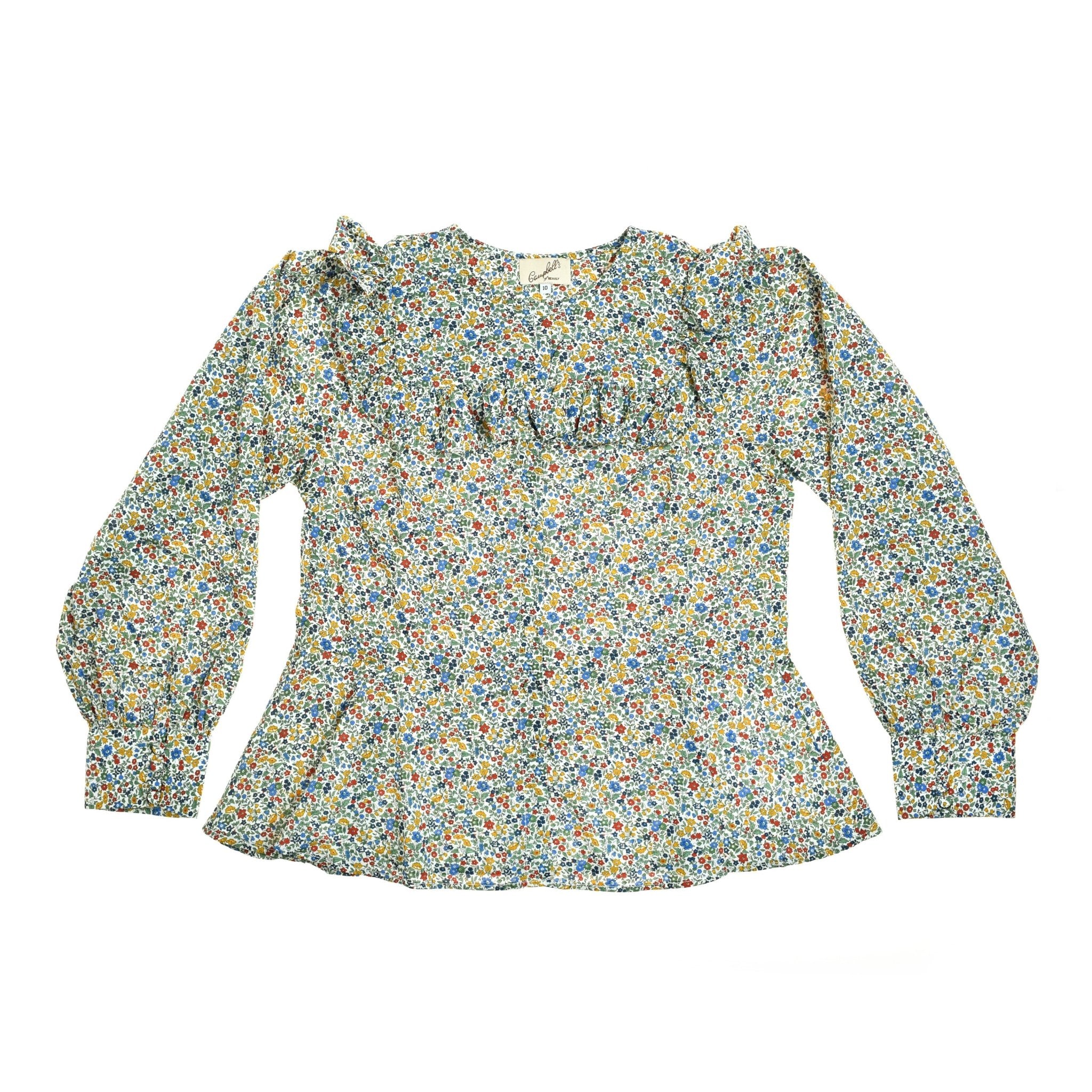 The Auld Stock Liberty Print Peplum Shirt by Campbell's of Beauly features a ruffled yoke, vibrant floral Tana Lawn cotton, round neckline, puffed long sleeves, and gathered cuffs.