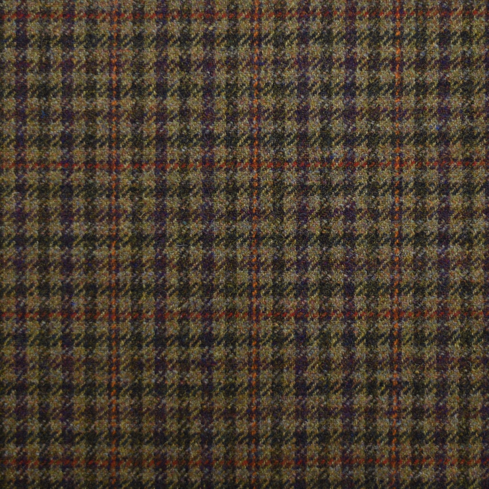 A close-up of House Tweed 84958 by Campbells of Beauly shows its textured weave and expert craftsmanship, featuring a checkered pattern in olive green, purple, orange, and brown.